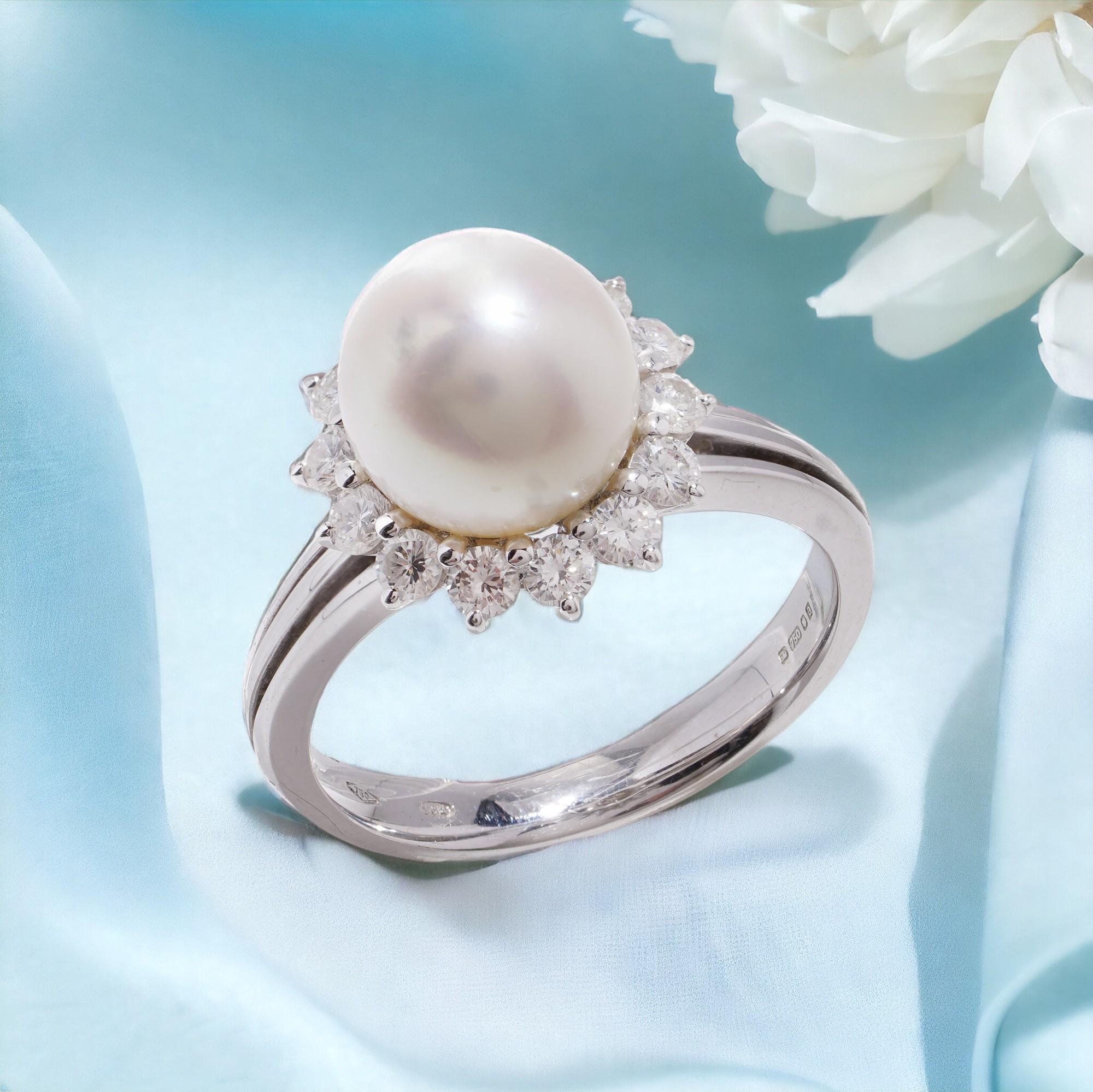 Mappin & Webb 18kt. white gold Cultured South Sea Pearl cluster surrounded by round brilliant diamonds. 
Made in England, London, 1956
Maker: Mappin & Webb 
Fully hallmarked.

Dimensions -
Finger Size : (UK) = O (US) = 7.5 (EU) = 56 
Weight: 6.8