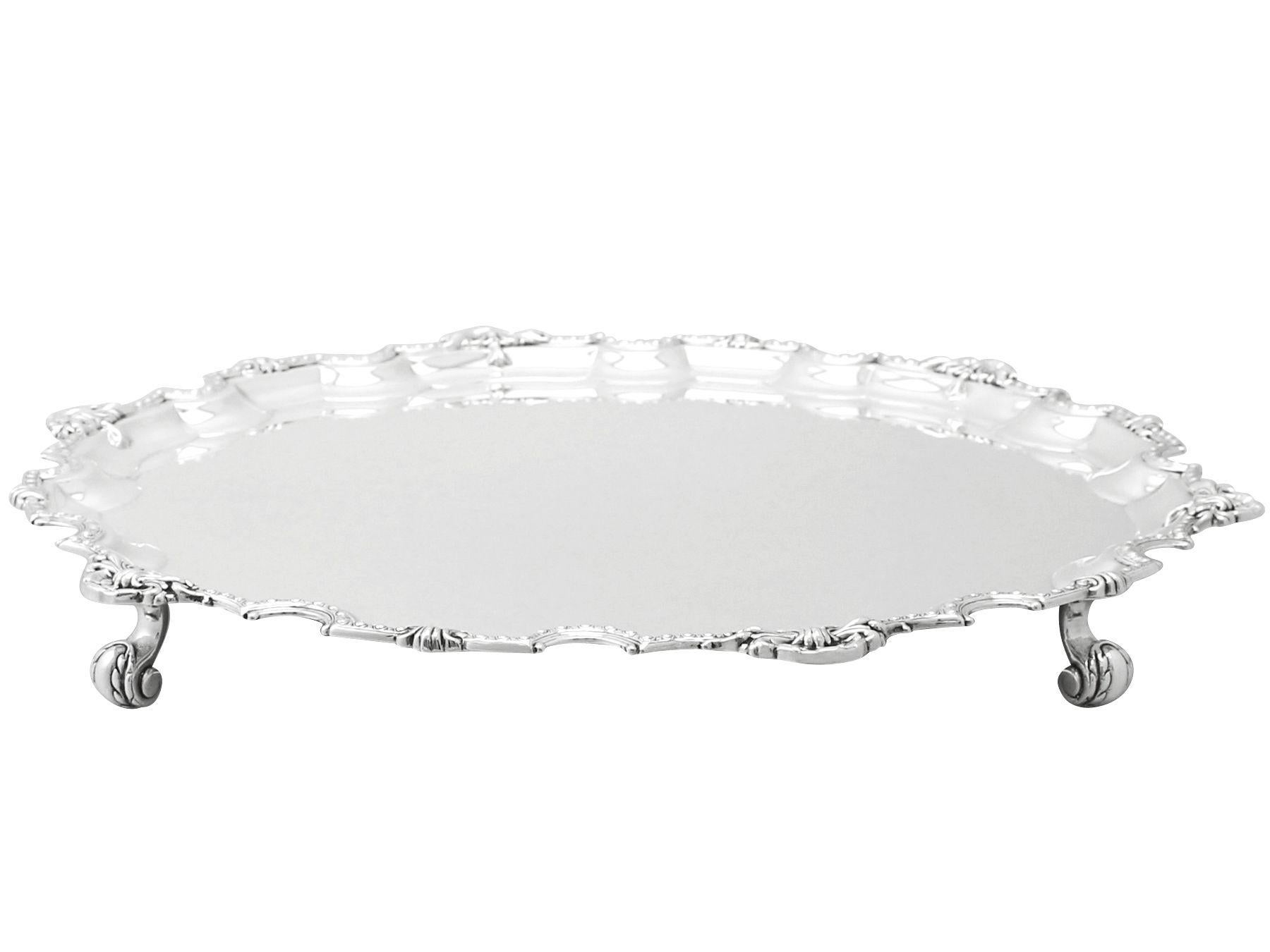 An exceptional, fine and impressive vintage Elizabeth II English sterling silver salver; an addition to our silver dining collection.

This exceptional vintage Elizabeth II English sterling silver salver has a circular shaped form onto four