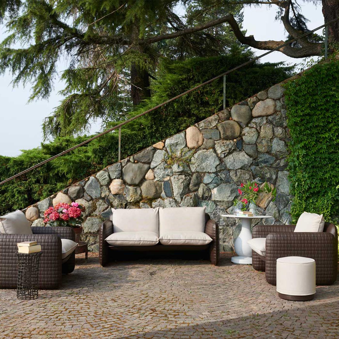 The woven leather is the main feature of the texture of Mara, a lounge armchair designed by Lorenza Bozzoli. This unique texture matches perfectly with the fabric cushions, waterproof and available for outdoor spaces. The comfortable seat of Mara is