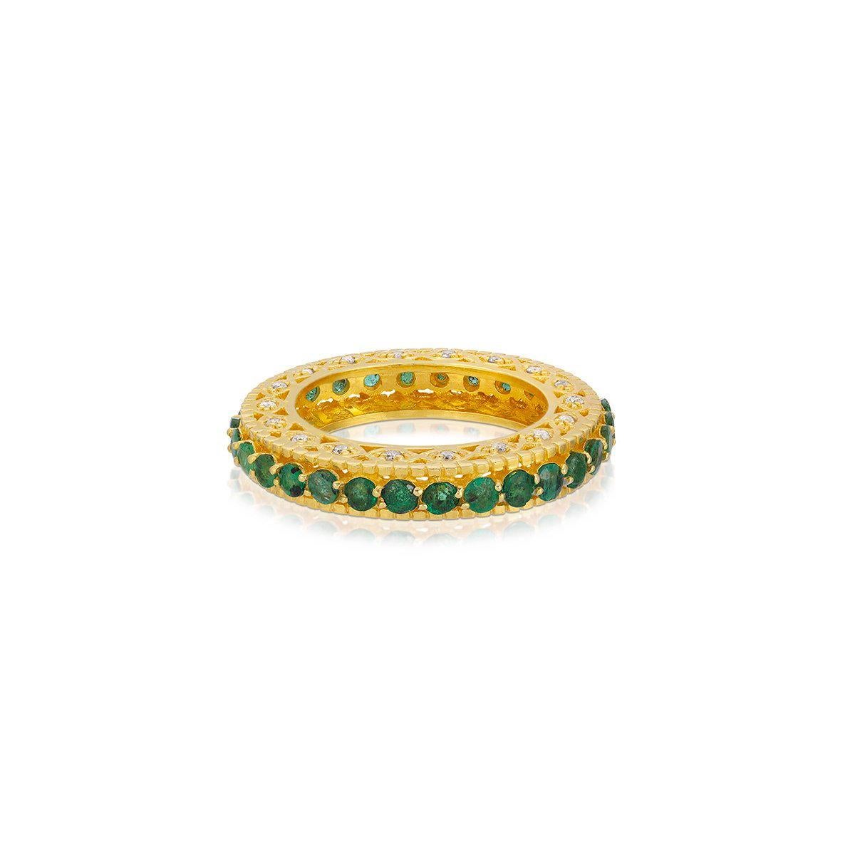 The Mara Emerald Eternity band... fully set with fiery Emeralds featuring an opulent filigree depth studded with Diamonds. 

- Natural Emeralds weight approx 2.56 Carats.
- White Diamonds weight approx .62 Carats.
- Set in 22 Karat Gold overlay