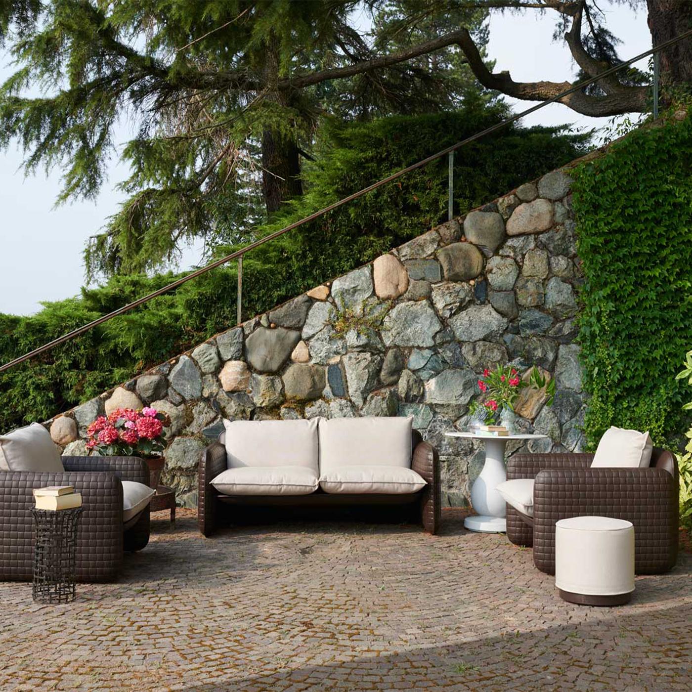 Mara sofa is a loveseat designed by Lorenza Bozzoli. Its unique texture covers the whole body of the sofa and it is inspired by the crafts woven leather. The cushions give comfort to the guests and make Mara Sofa suitable for indoor and outdoor: the