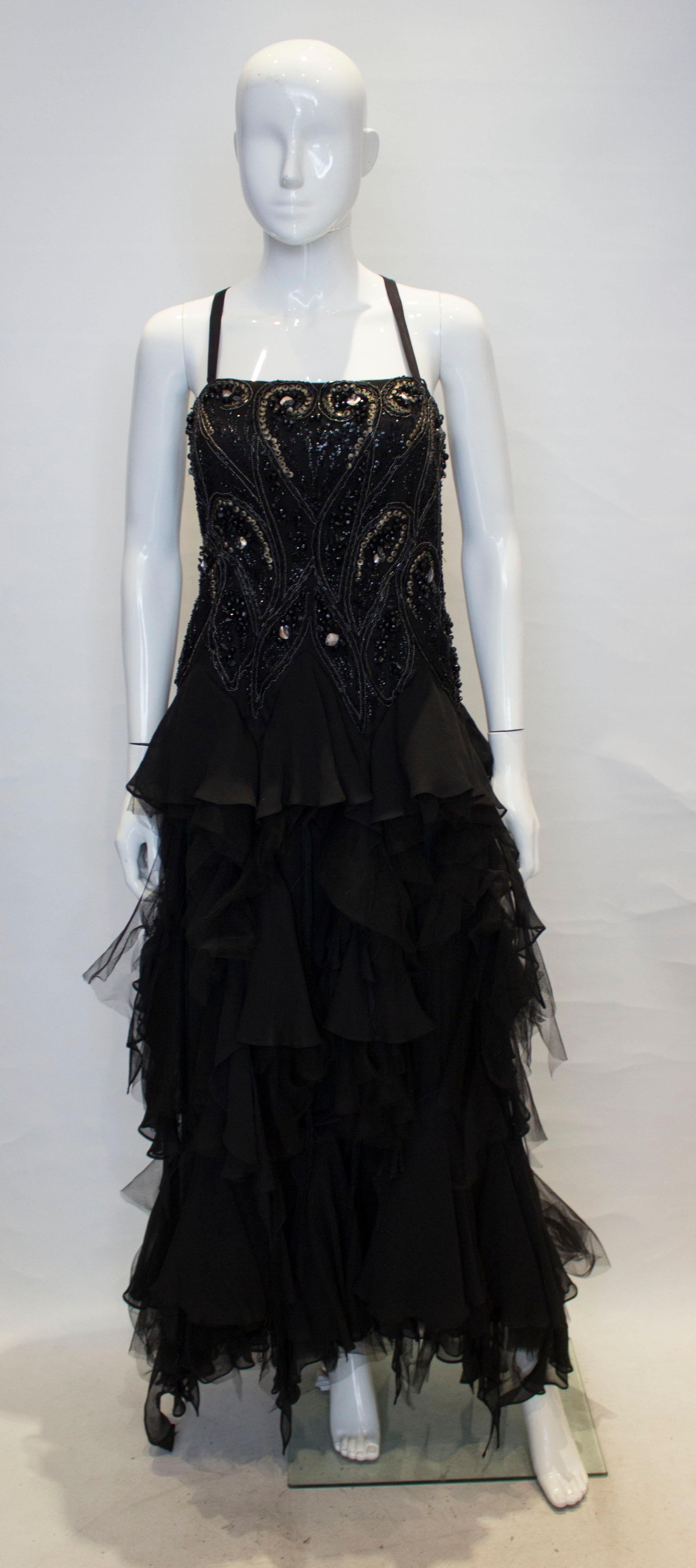 A great gown for Halloween, by Maralane.The dress has a beaded and decorated bodice with shoulder straps, and a net and tired skirt. It is fully lined.