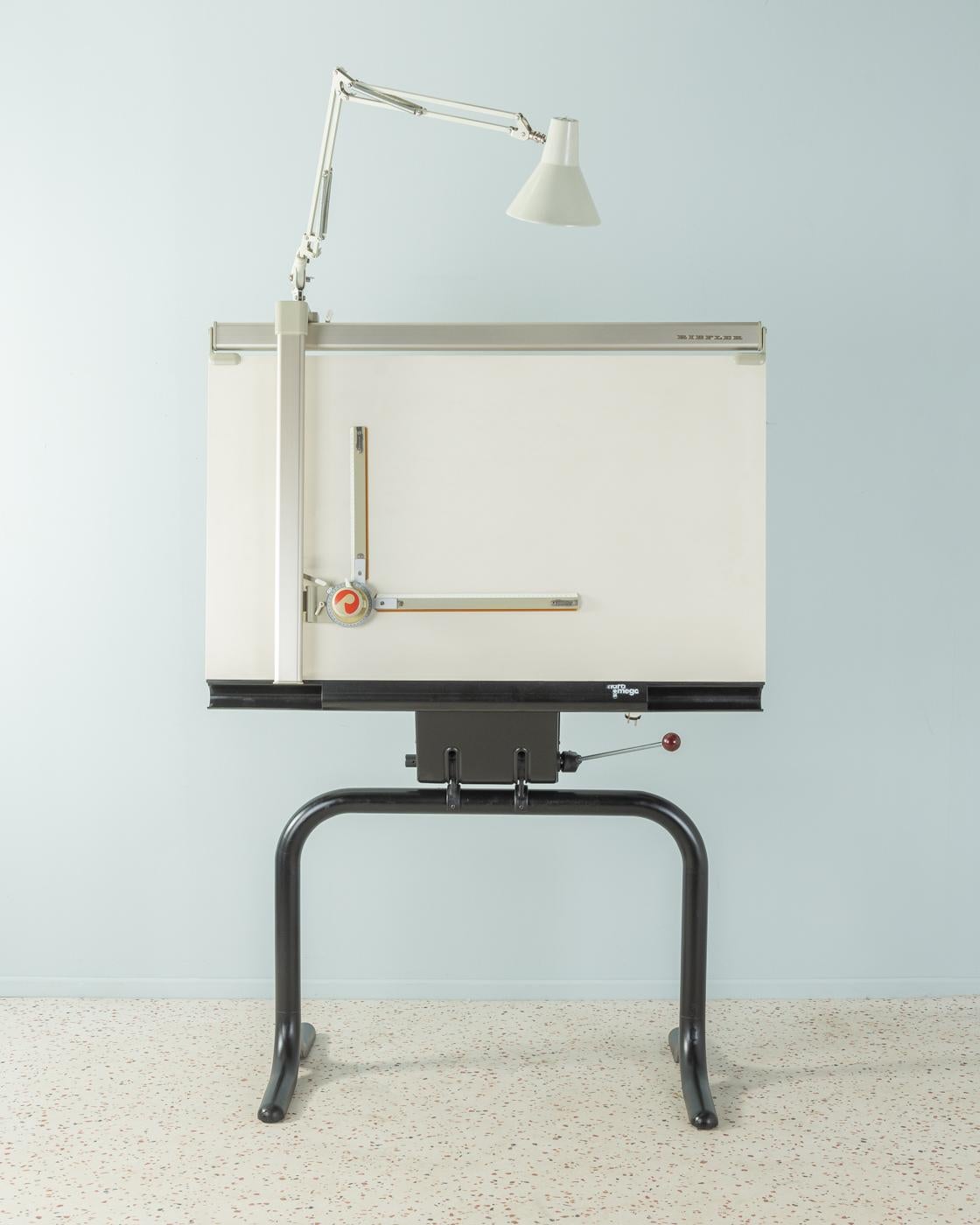 Rare architect drawing table model Maramega from 1979 according to a design by Popp. Very high quality construction of black painted steel, a drawing table with precision drawing system from Riefler and the original lamp. The frame is height