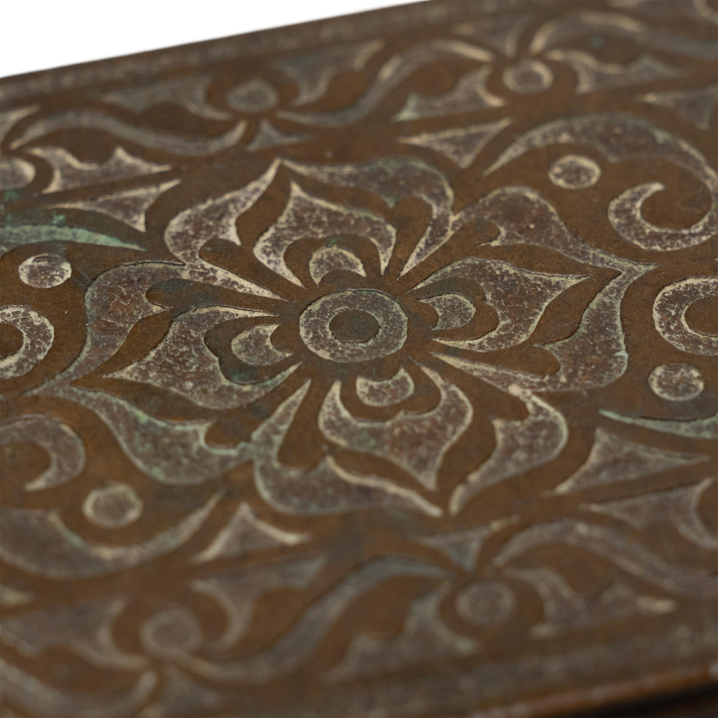 Decorated in relief and cloaked in an antique patina, this curious brass case is an early 20th century betel nut box, attributed to the Maranao people of the island of Mindanao, Philippines. The rectangular box is decorated across the exterior with
