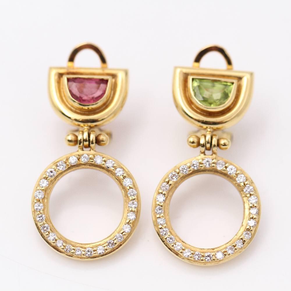 PeDiamond stud earrings for women  50x Brilliant Cut Diamonds weighing approx. 0.50ct in G/Vs quality  1x Pink Tourmaline and 1x Green Peridot weighing approx. 0.35ct  Omega Clasp  18kt Yellow Gold  10.61 grams.  These earrings are in excellent