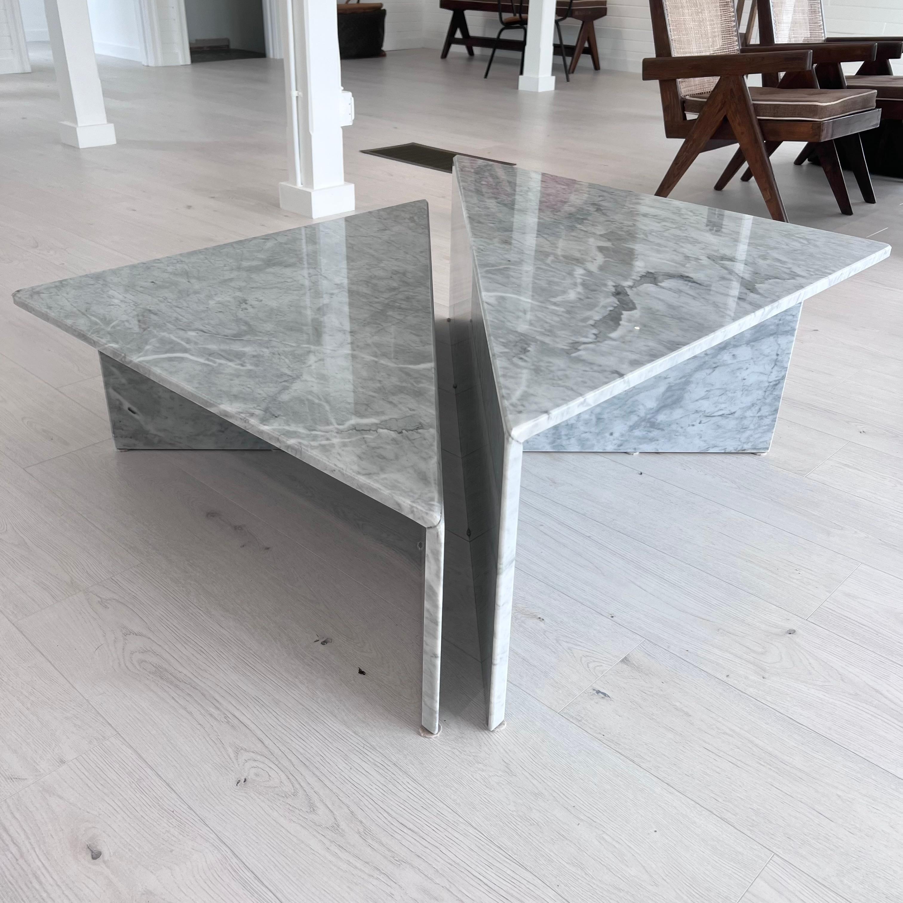 Elegant Carrara split marble cocktail table. Perfect scale. Stunning lines with sharp angles and features make this table quite eye catching. The table consists of 2 independent triangular halves which combine to create a full square coffee table.