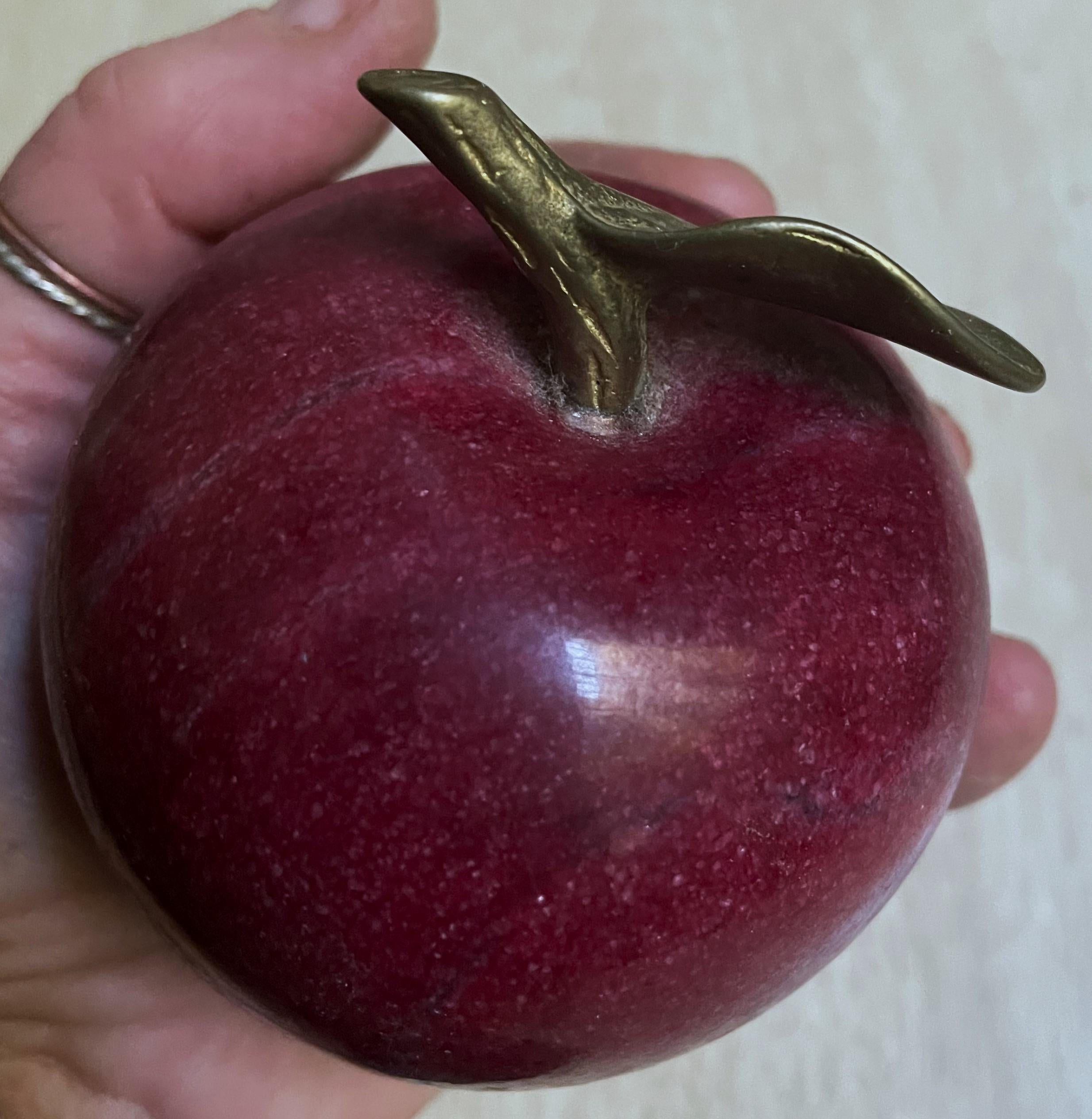Here is a vibrant red and realistic looking heavy shaped marble apple with nice hefty brass stem. It has an intriguing sparkle and good grain in the natural stone and I only see a tiny scratch on the silky smooth surface. There is a gold sticker on