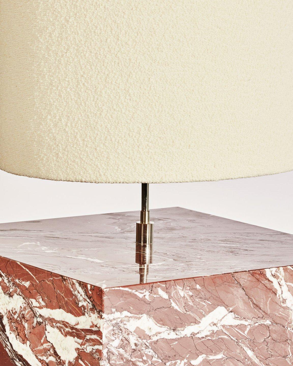The Coexist floor lamp consists of a marble cube base and a lampshade made from boucle fabric.

The special lamp serves as a sculptural centerpiece for any room, emitting a soft warm light to draw the viewer into the materials. The bold geometry
