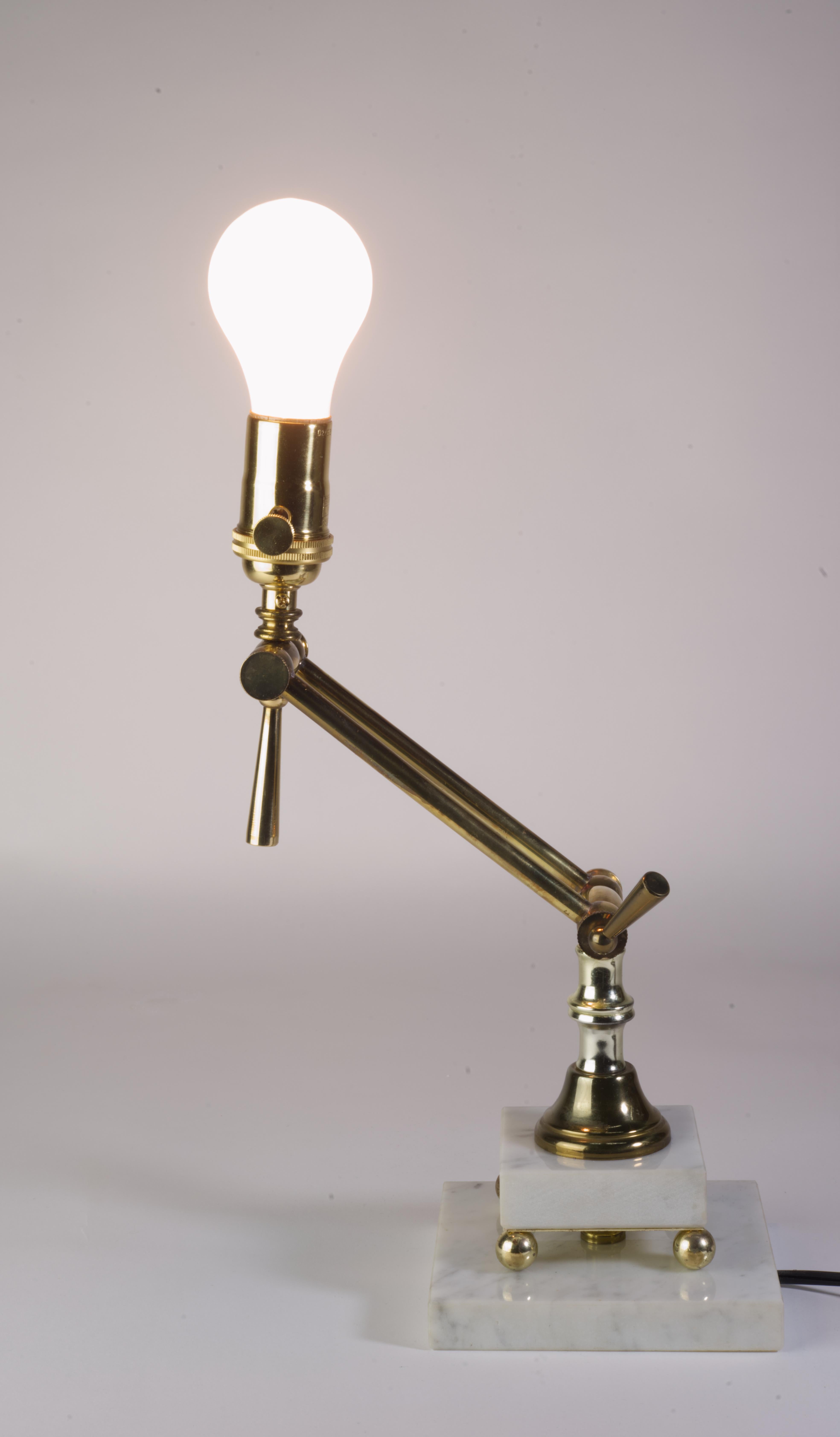 Adjustable Brass and Marble Table lamp from 1970s.
Marble has no damages. Brass has some patina. All joints work well. 
Shade has couple of small dings. If you are planning on using your own shade, lamp can be shipped for less. 