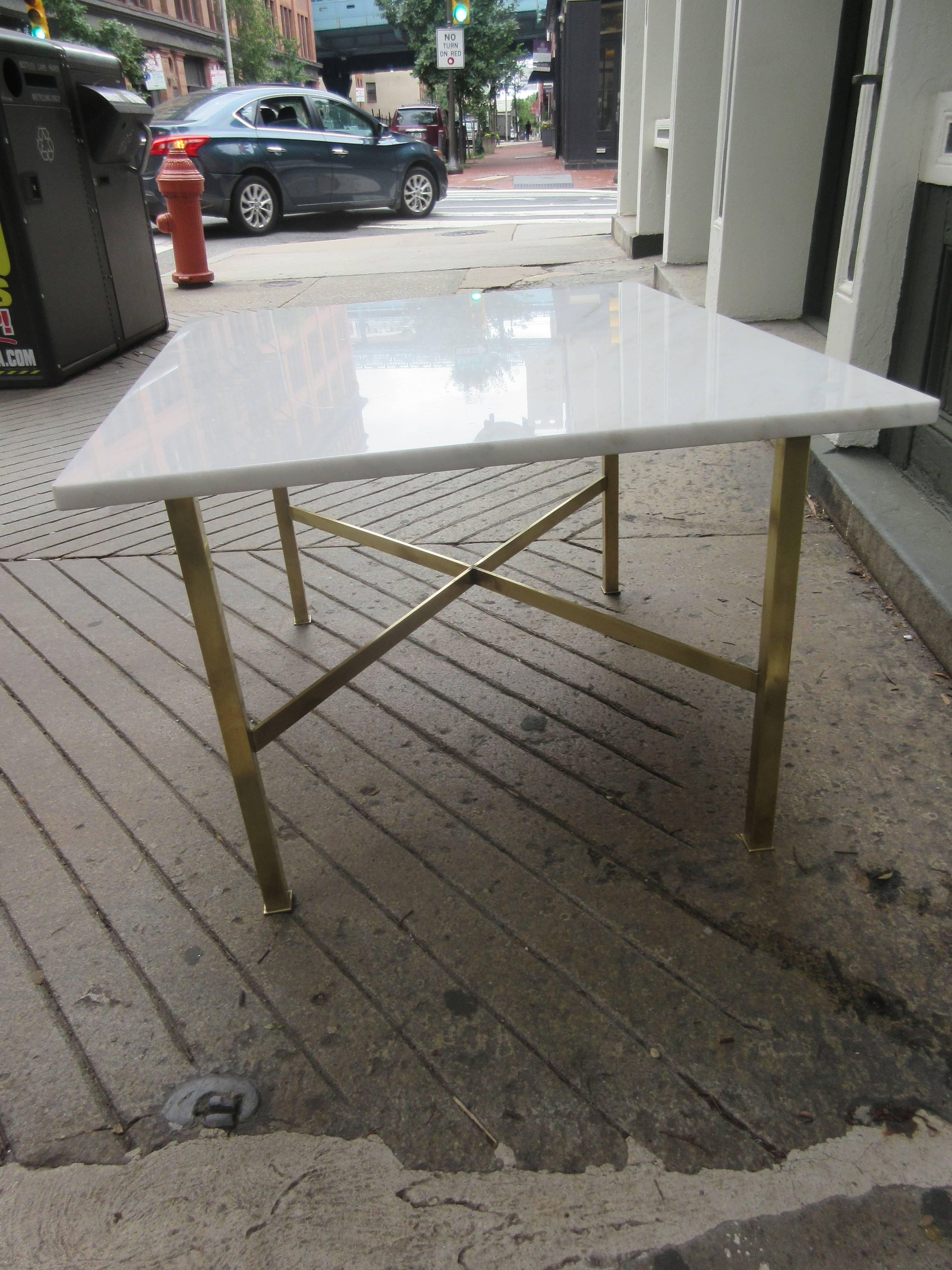 Marble and brass coffee/end table in the style of Paul McCobb with brass cross braces and square pod feet.