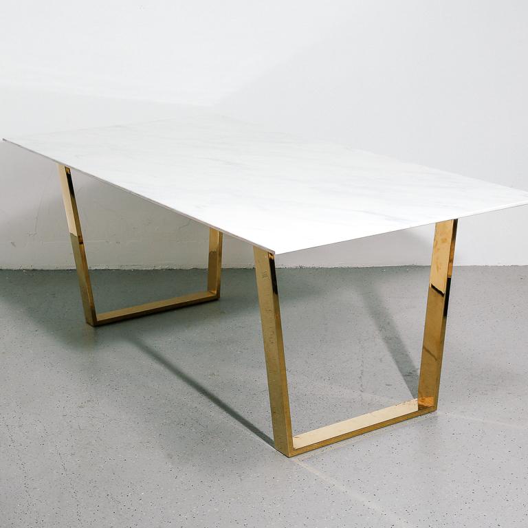 Vintage dining table with white marble top and angular brass-tone base. Seats at least 6.