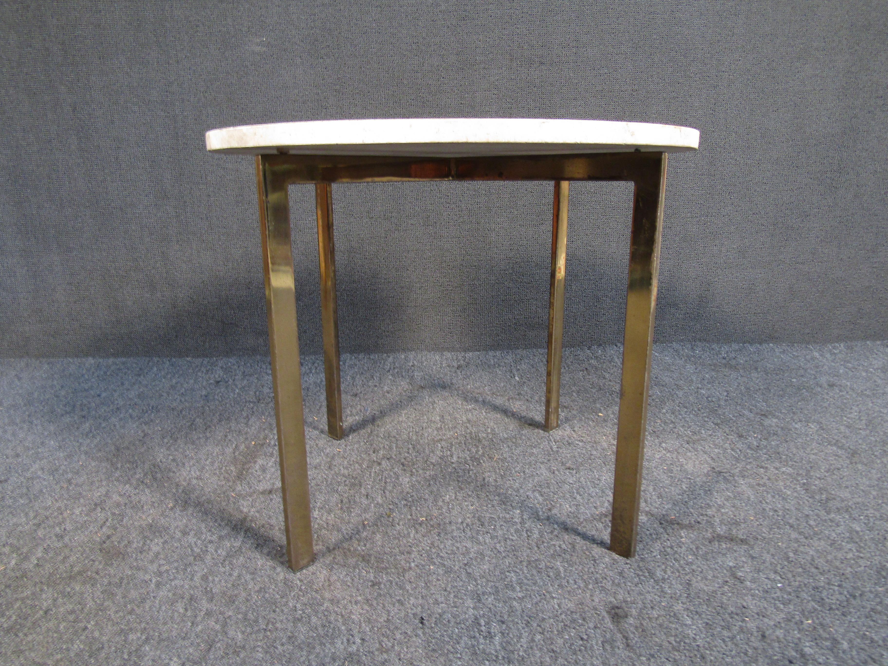 Pairing a rounded marble top with an elegant brass base, this vintage side table has eye-catching style anywhere it's placed. Please confirm item location with seller (NY/NJ).