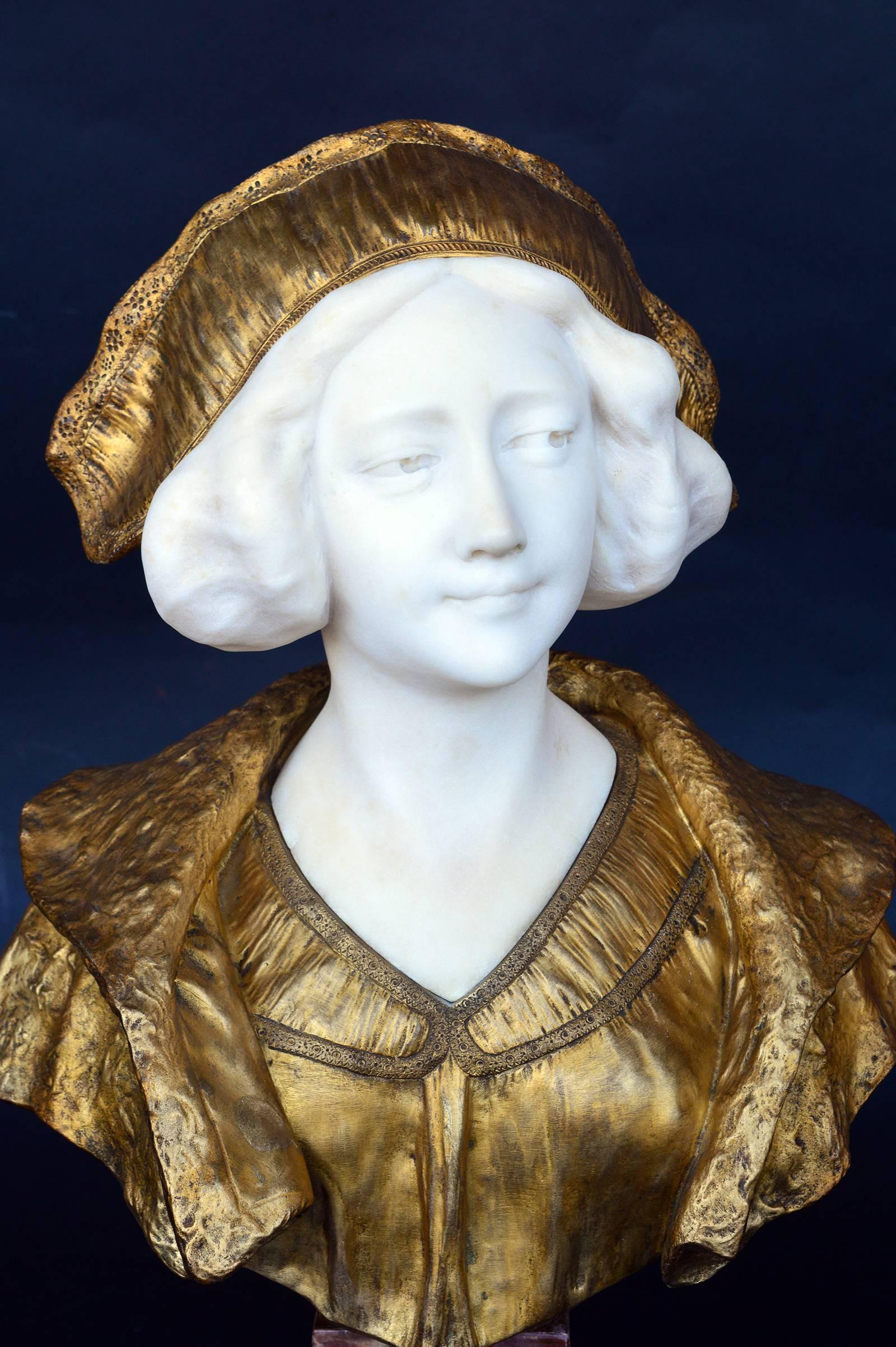 A bust of a woman signed by Gory, France. Face in marble, hat and bust bronze-mounted on a red marble stand.