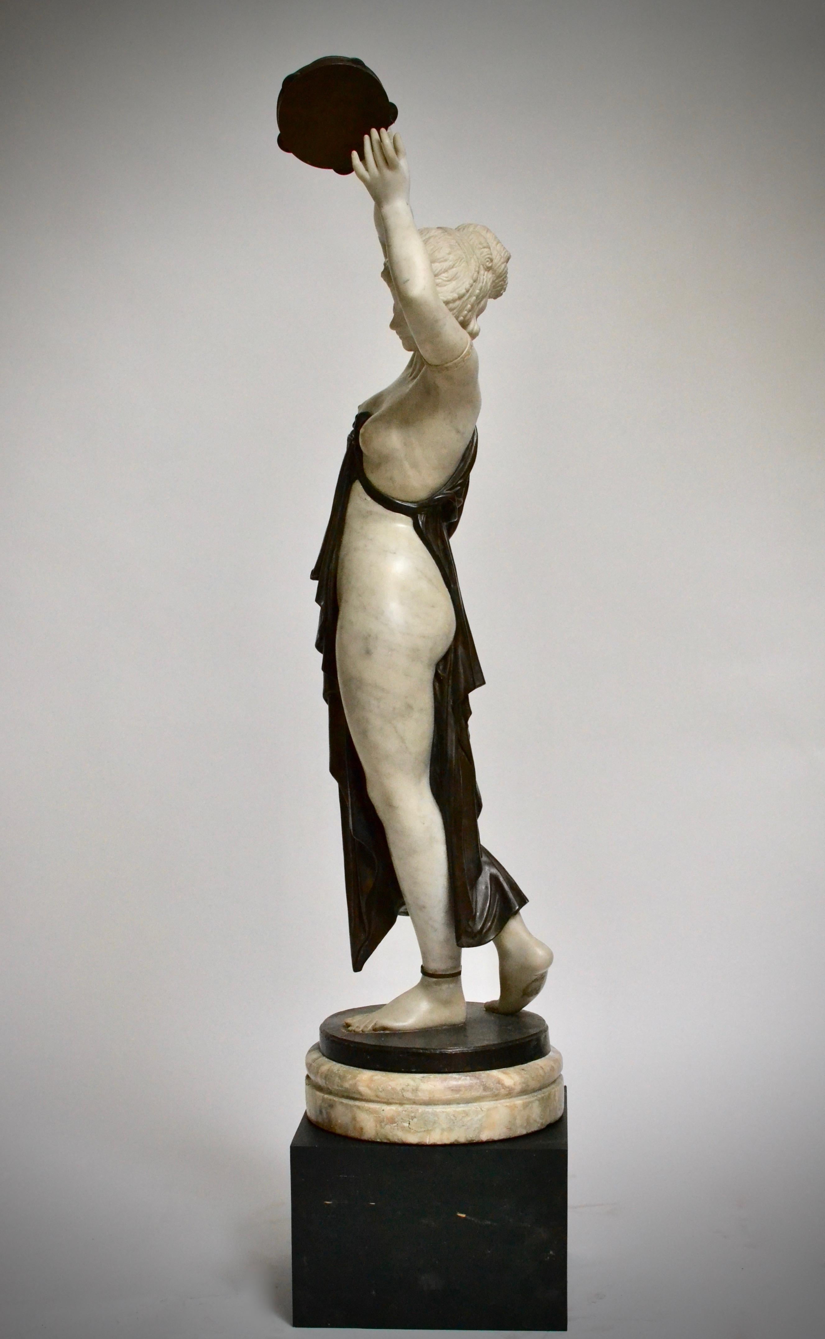 sculpture of woman holding man