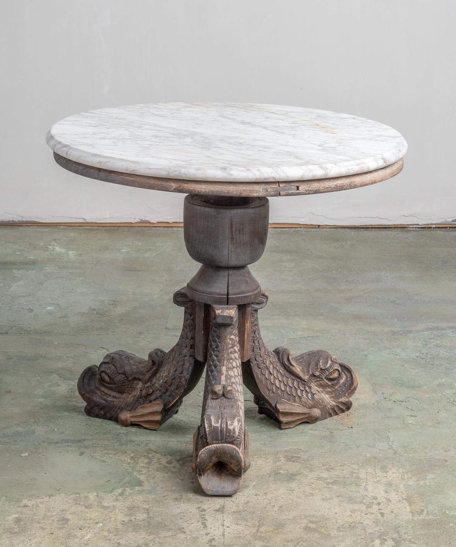 Marble and carved wooden side table, circa 19th century.

A beautiful top sits on a well patinated, hand carved base with dolphin legs.