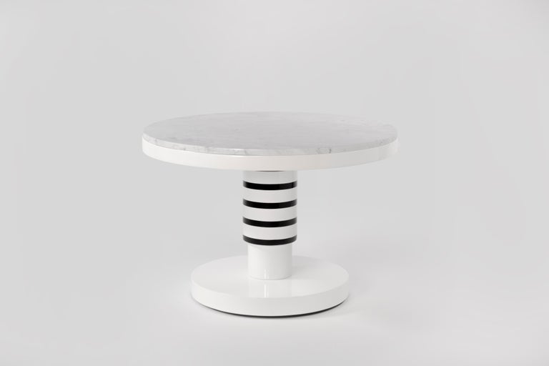 Marble and ceramic coffee table by Eric Willemart
Materials: Top: Polished Carrara marble paate embedded in a white lacquered 
 Wooden Tray
 Body: Handcrafted ceramic glazed in black, white and silver finishes
 Base: White lacquered wood on an