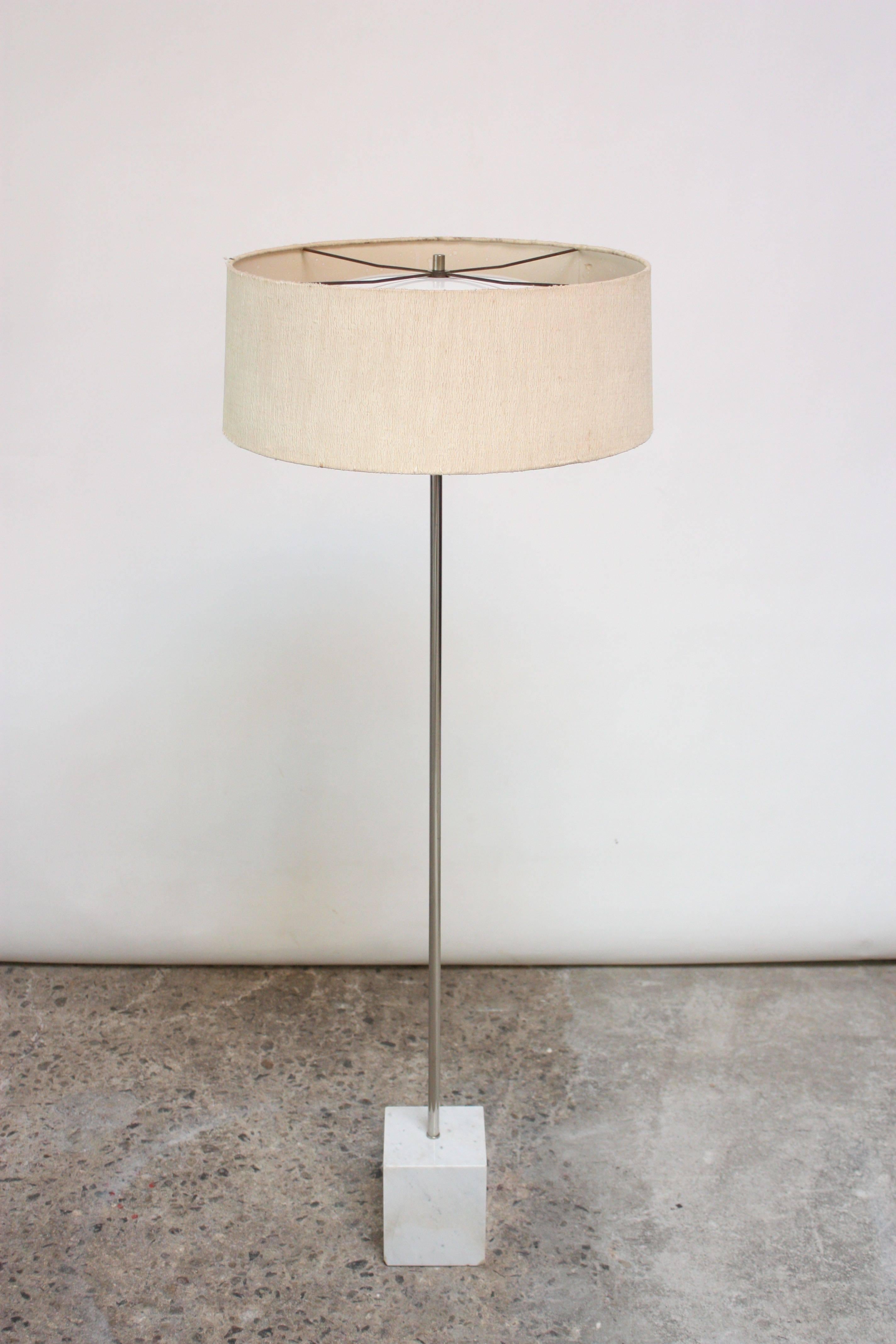 Laurel floor lamp with square marble base and chromed-metal rod. Features three socket illumination, newly rewired and ready for immediate use. Includes period cylindrical shade with top and bottom diffusers for even distribution of light.
Minor