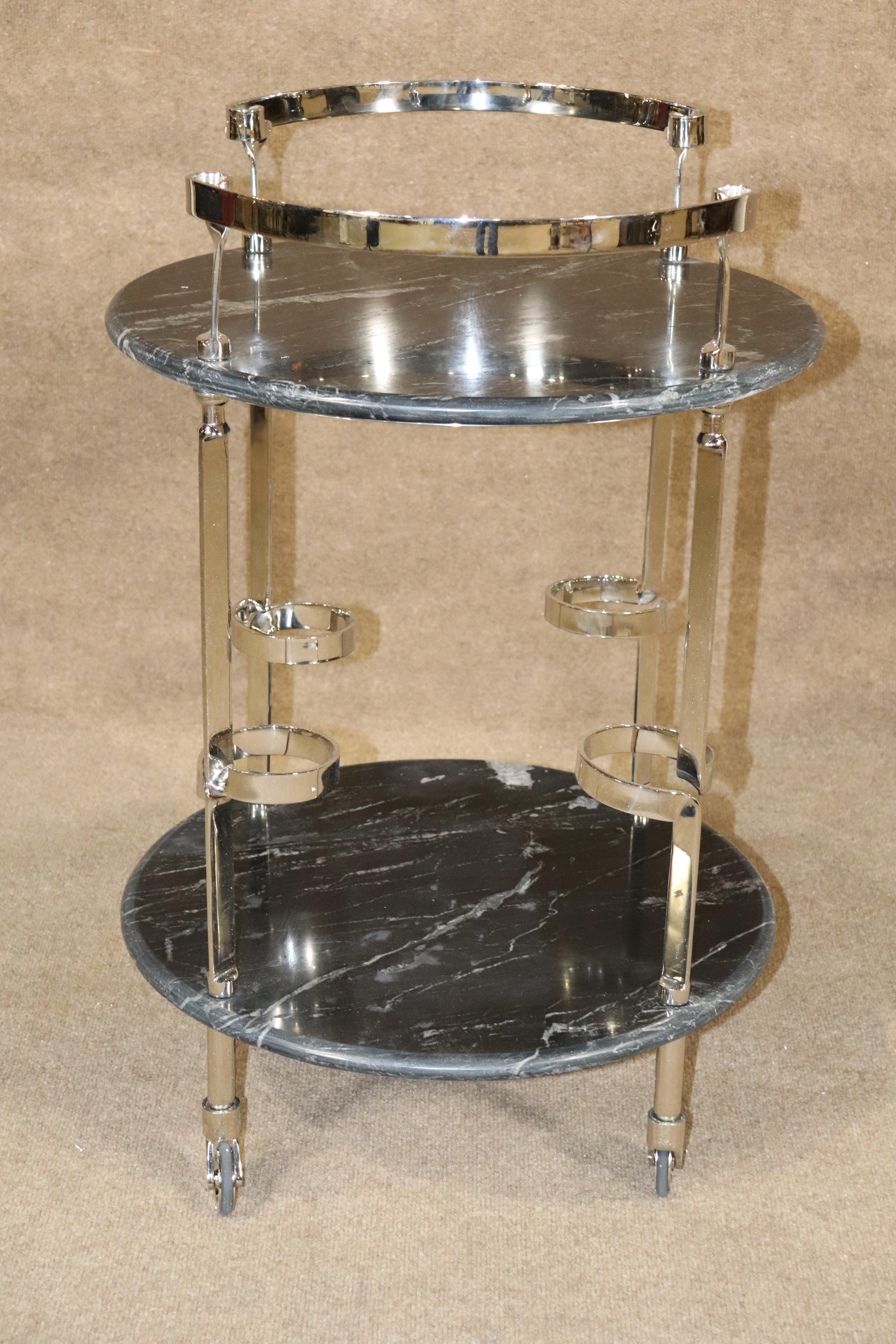 Rolling bar cart made of thick marble and polished chrome. Four rings for bottles and tray area for glasses and accessories. 
Please confirm location NY or NJ.