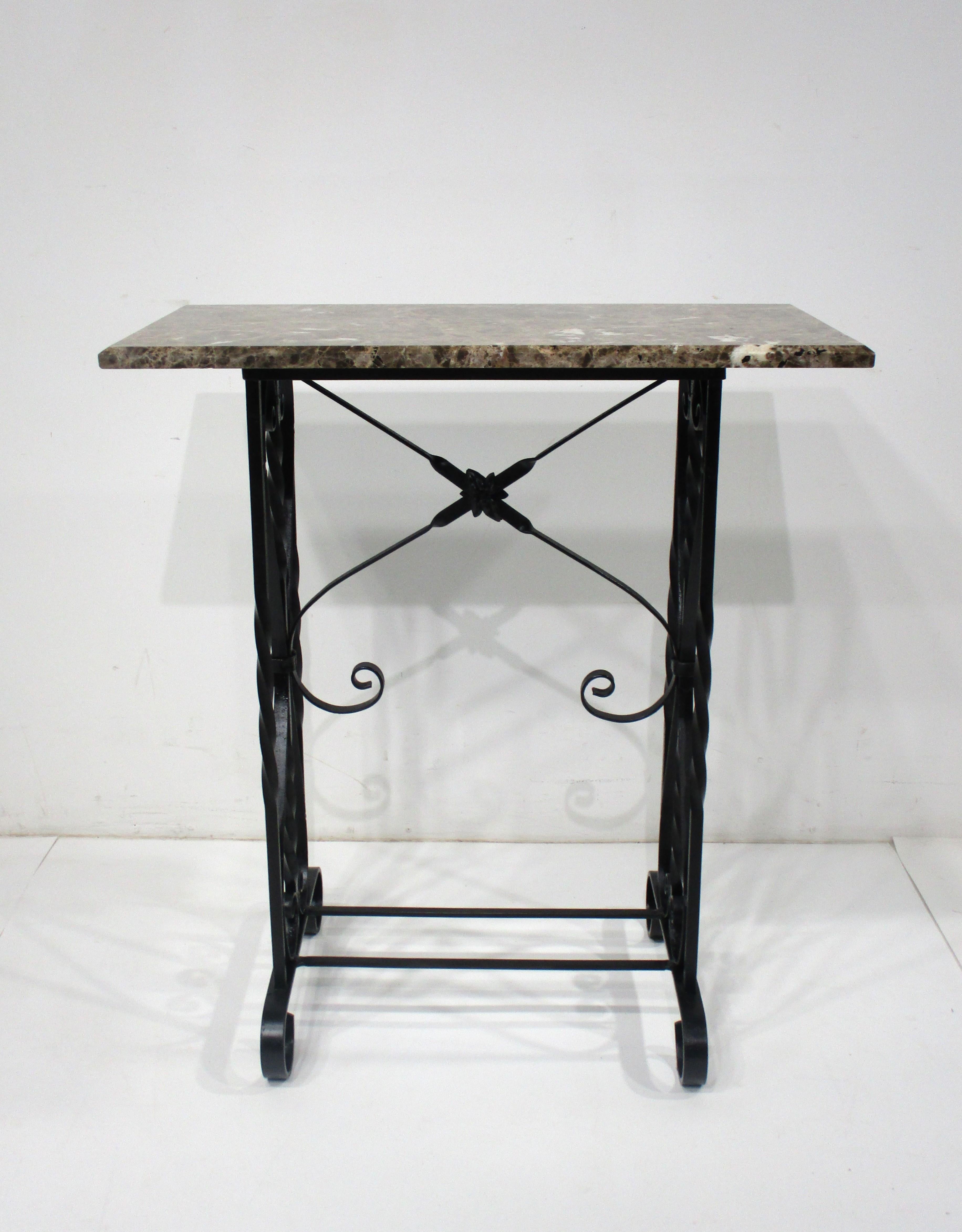 A very well crafted twisted and forged black iron based Art Deco styled console table with wonderful beveled marble top . The perfect piece for that hallway , under a mirror or in an entrance way . This two piece console table is functional and is a