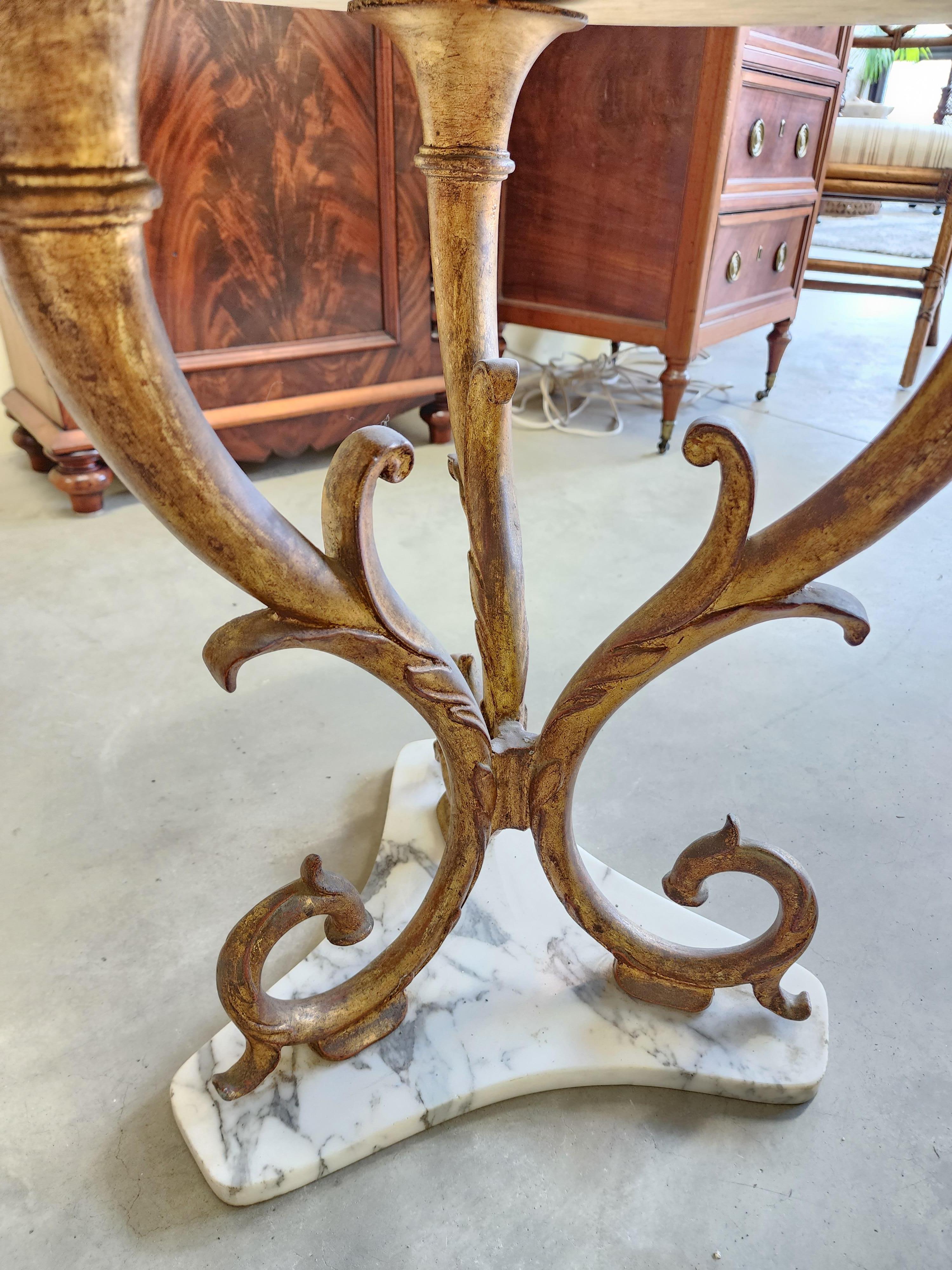 Mid-Century Modern side or occasional table with a beautifully matte surfaced carrara marble set upon a gilded iron frame.
Italian circa 1960s. 
This item can be picked up by the purchaser in either our Hudson New York Warehouse or Great