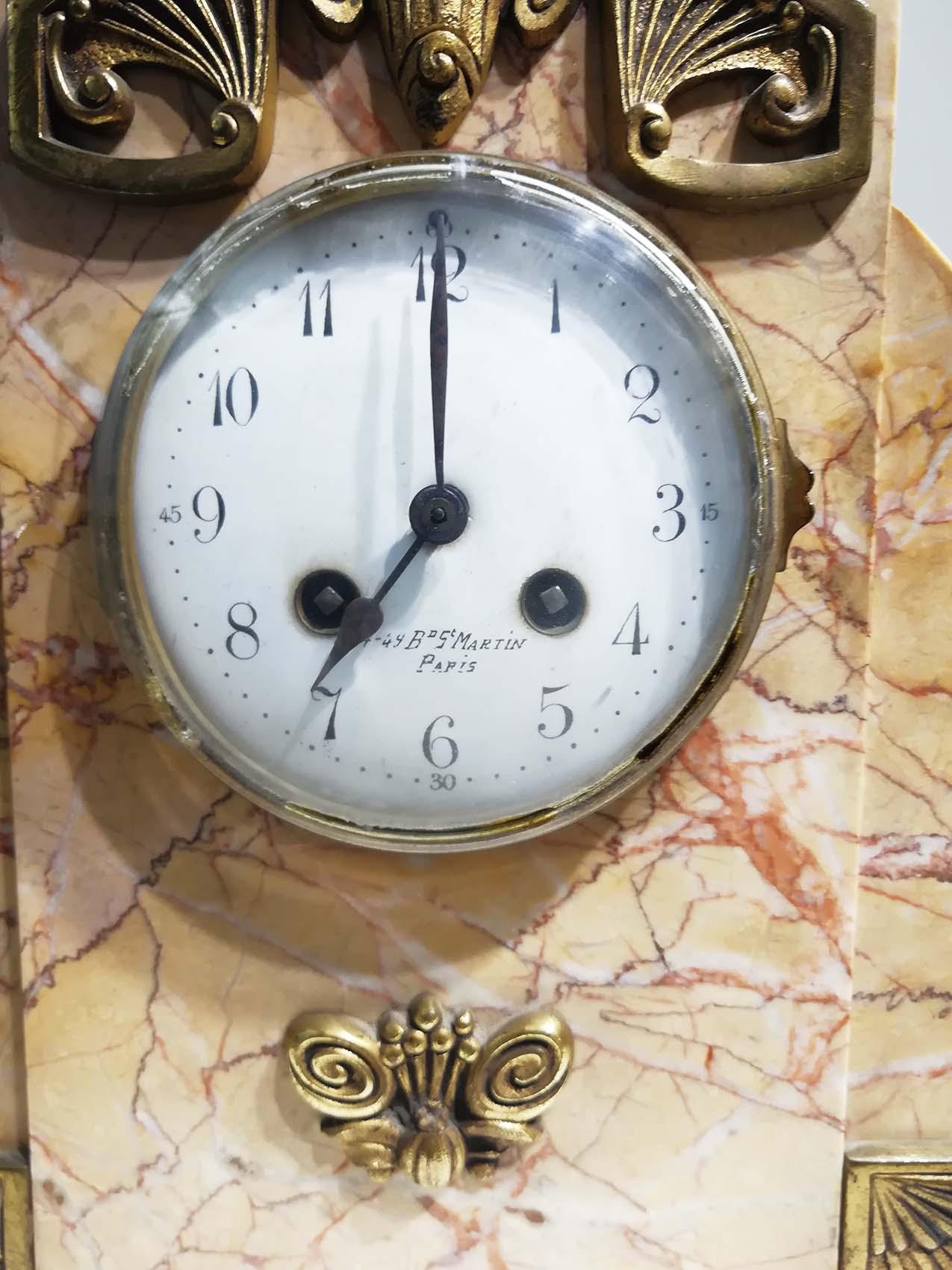 Vintage French Art Deco mantle clock set in marble and bronze. Arch shaped and includes two ornamental 