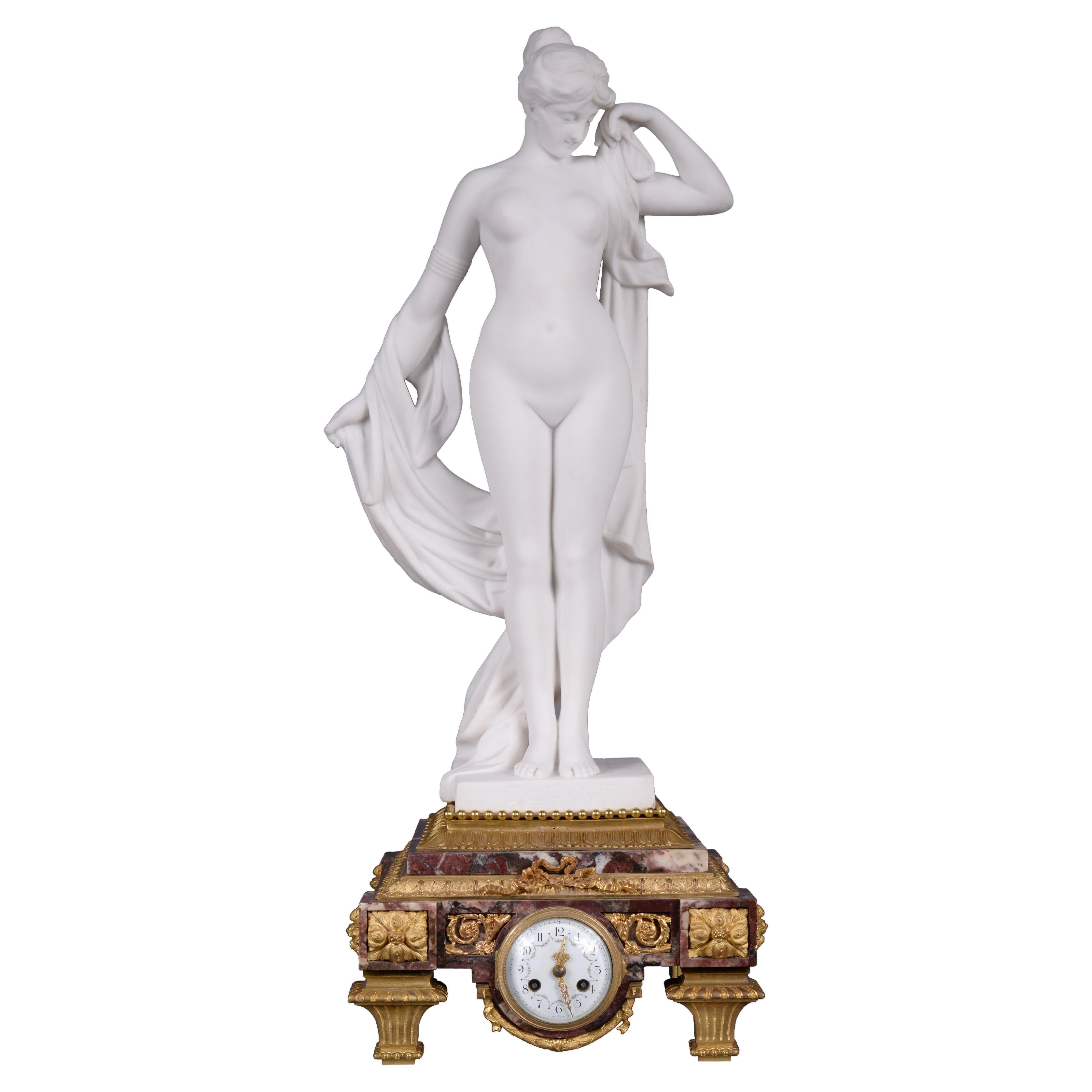 Marble and gilt bronze clock surmounted by a statuary white marble sculpture