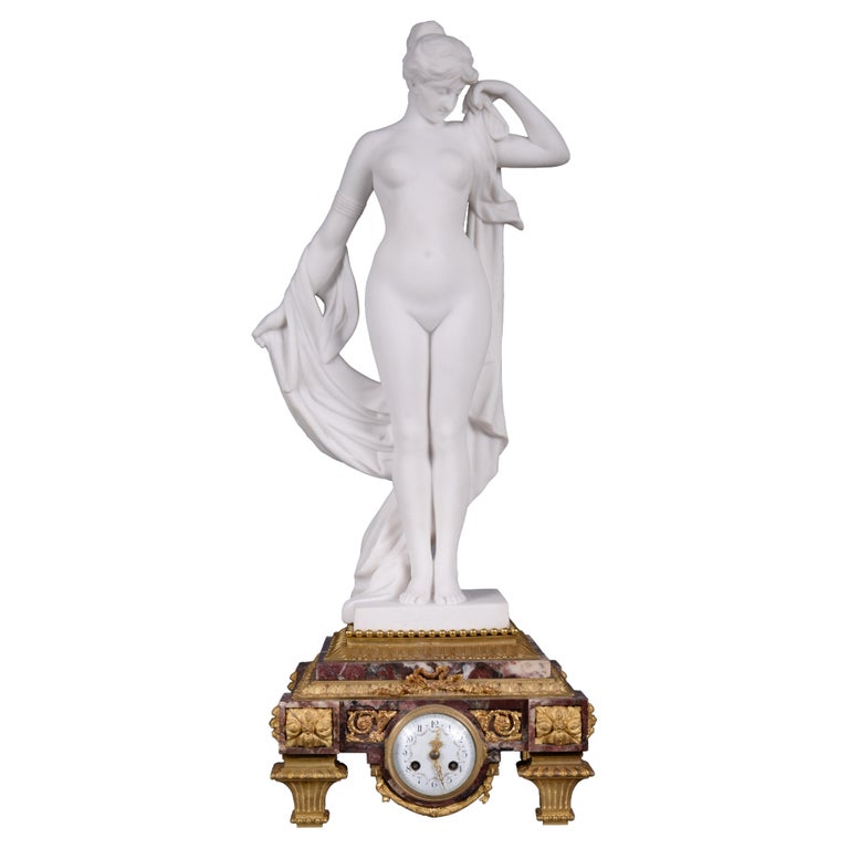 Marble and gilt bronze clock surmounted by a statuary white marble sculpture For Sale