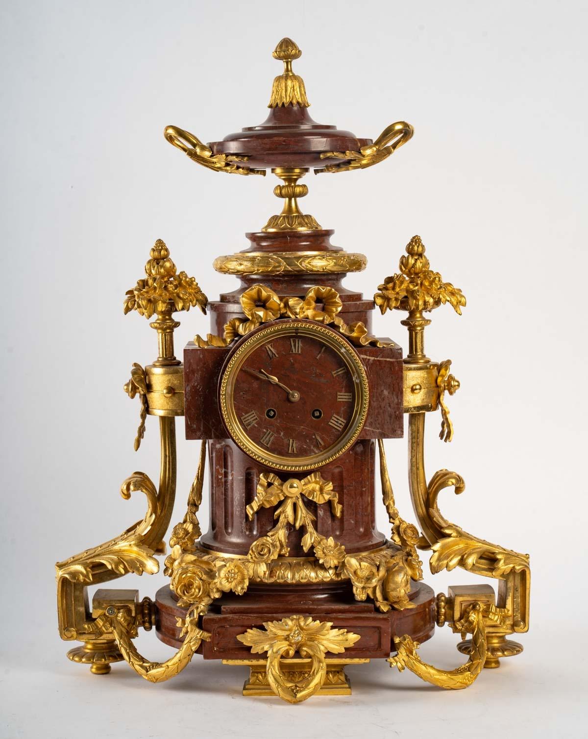 A Napoleon III period marble and gilt bronze mantelpiece, 19th century.
Clock - H: 56 cm, W: 44 cm, D: 25 cm
Candlestick - H: 70 cm, W: 30 cm, D: 24 cm
Cassolette - H: 21 cm, W: 19 cm, D: 14 cm.