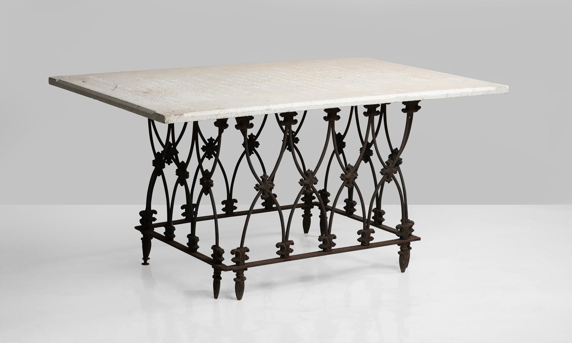 Marble and ornate iron garden table, America, 19th century.

Masonic building plaque on unique cast iron base.


      