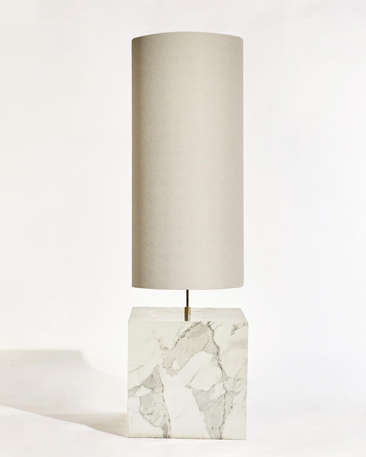 The Coexist Floor Lamp consists of a marble cube base and a lampshade made from recycled fabric.

The lamp serves as a sculptural centerpiece for any room, emitting a soft warm light to draw the viewer into the materials. The bold geometry of the