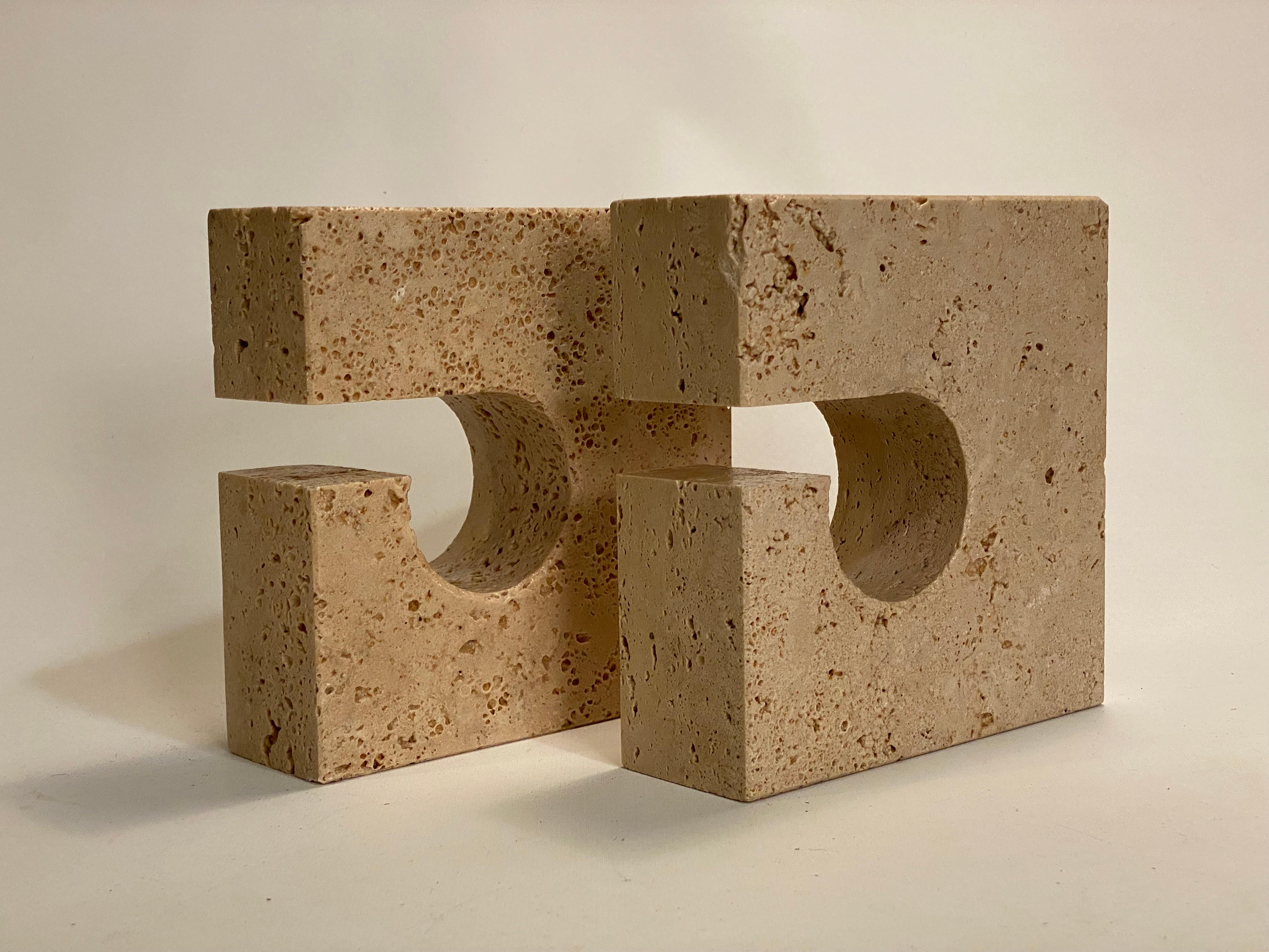 A fine pair of carved pierced carved geometric travertine bookends. Circa 1960-70. Signed with label, Marble Art, Marta (VT), Italy. Good overall condition with natural exclusions and inclusions. 

Approximately 2