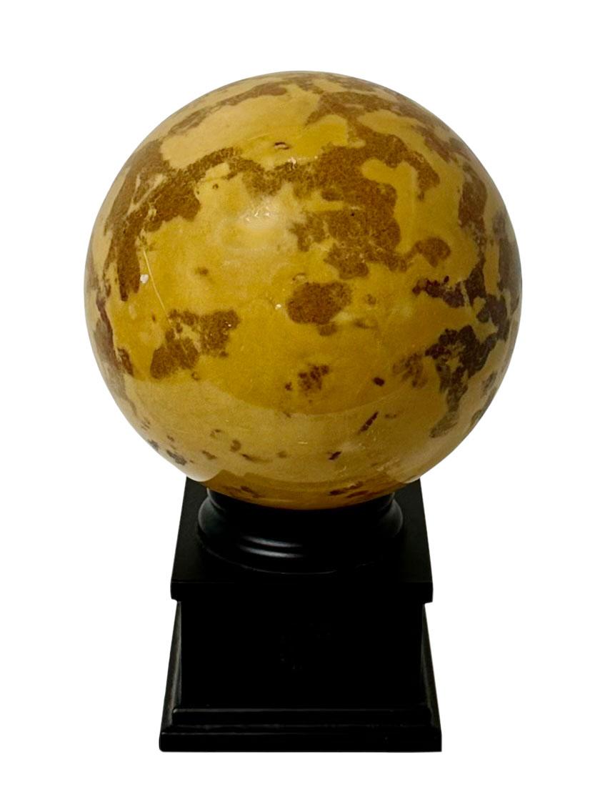 A turn of the century, Italian marble ball on a small black wooden base. The marble is polished and it is in great condition.