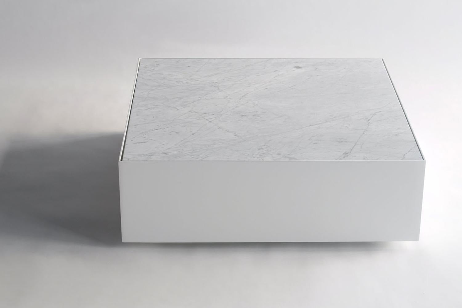 The ballot box invokes the spirit of minimalist artist Donald Judd. Crisp lines unify to create a steel box, and a sleek sunken marble top is punctuated with a rectangular cut out. The table is constructed out of steel and finished with chrome