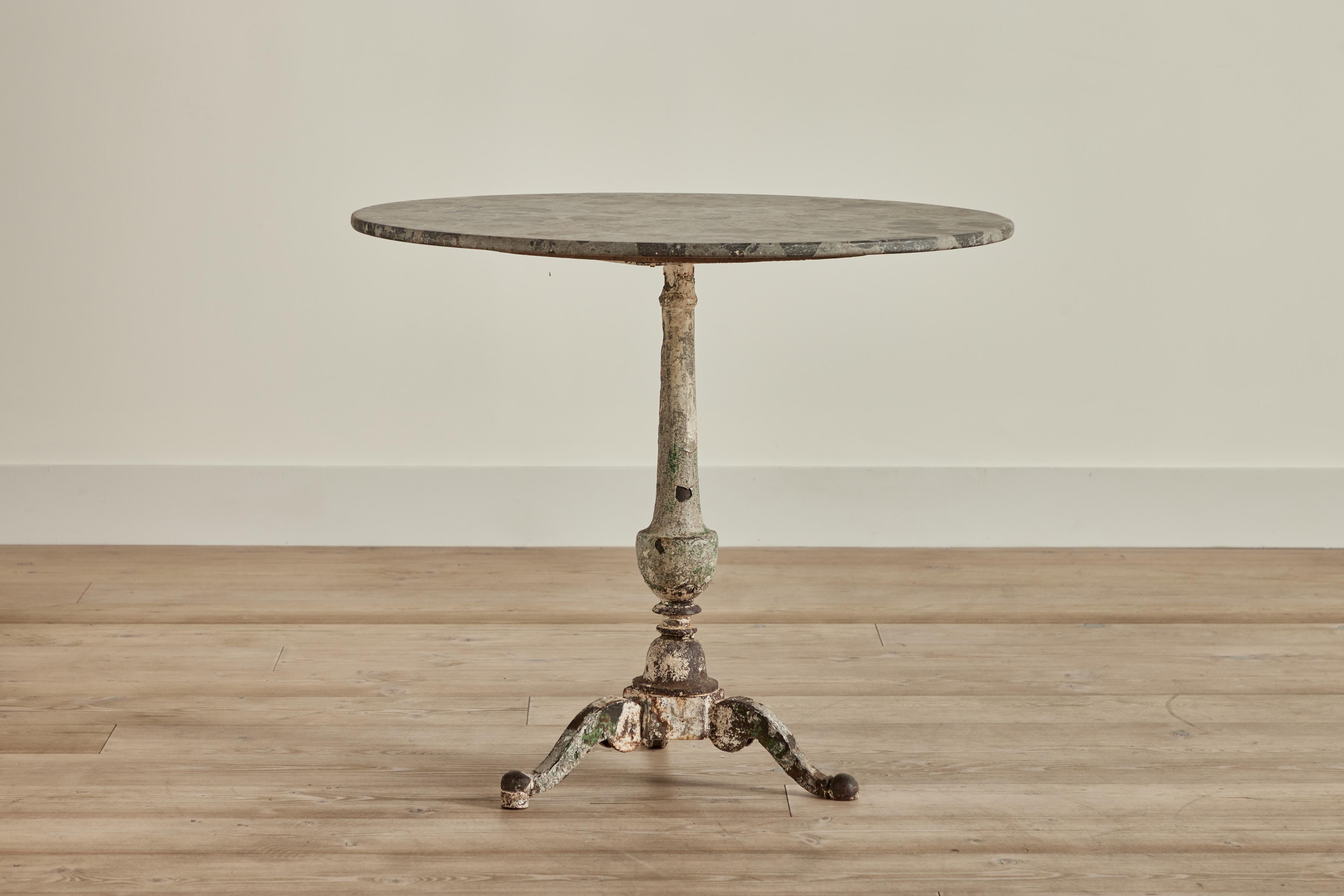 French cast iron and marble top bistro table circa 1900. Wear throughout that is consistent with age and use. 