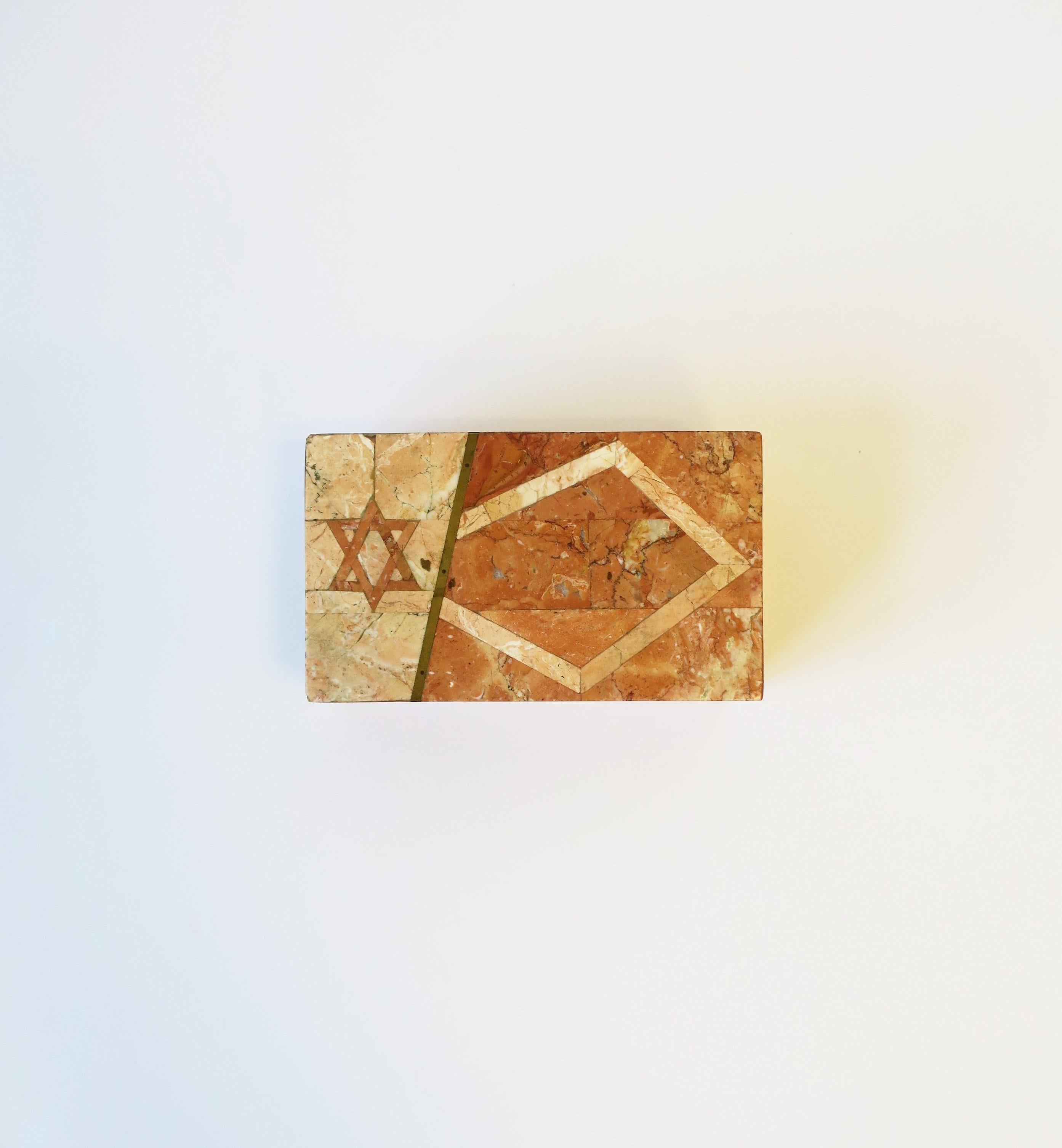 A beautiful modern style or Postmodern period marble and brass box with Jewish Star of David design, circa late-20th century, 1980s, 90s. Box, attributed to designer Maitland Smith, is rectangular with a wood interior. Marble veneer is various