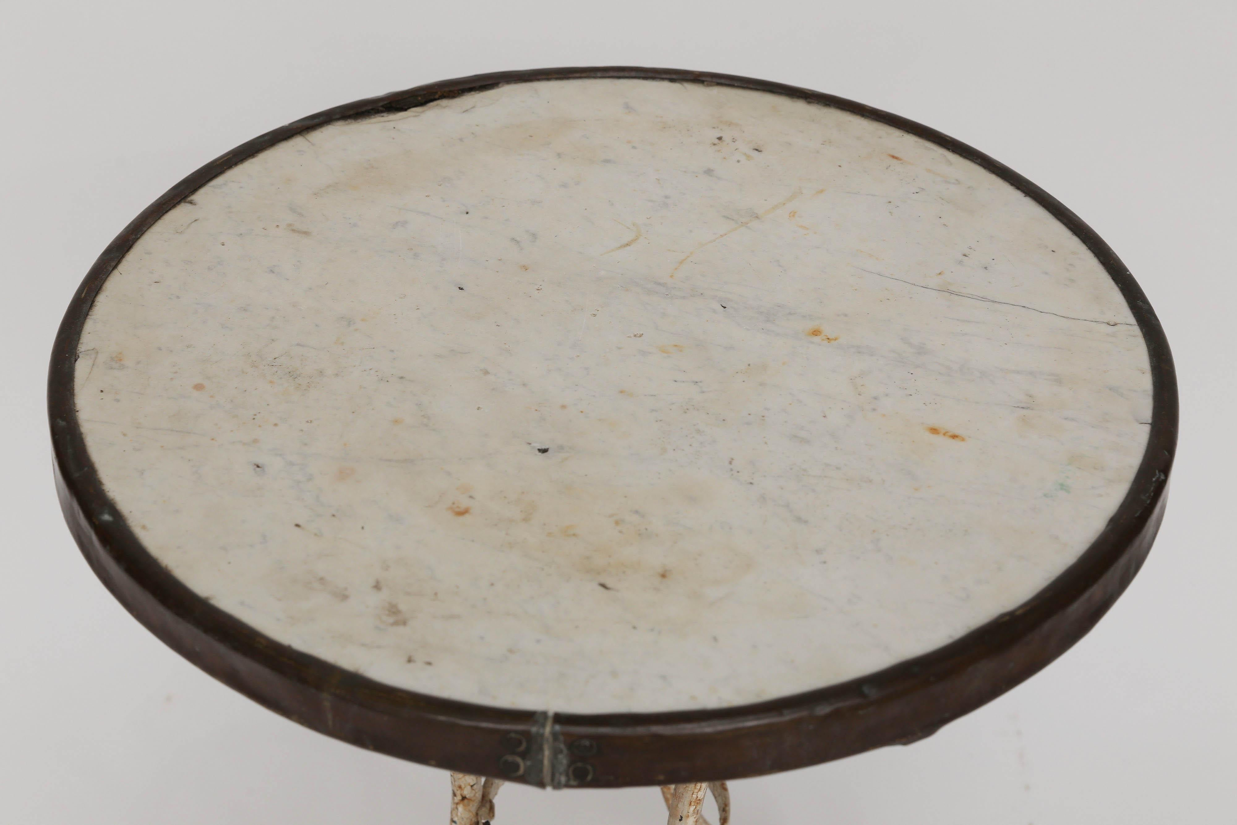 Antique French bistro table with marble top, brass band and wrought iron base. Beautiful patina from years of enjoyment.