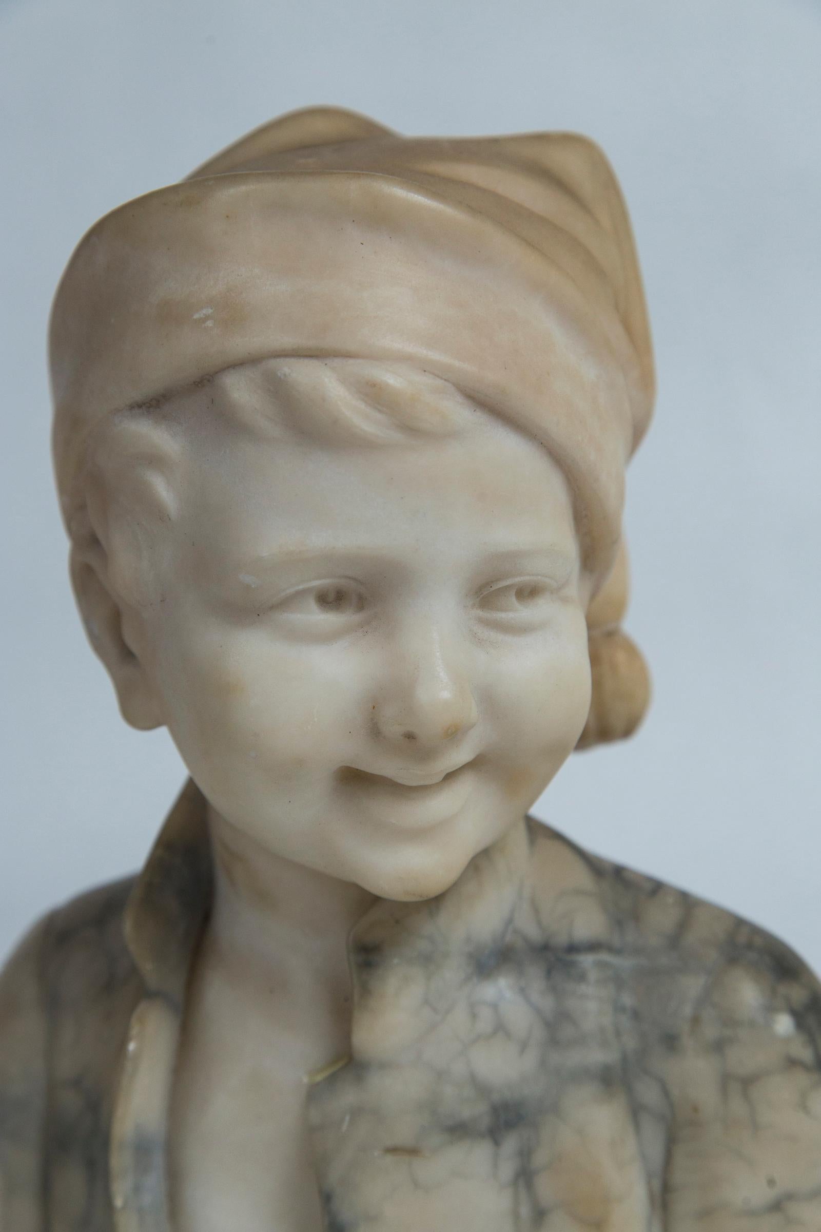 Hand-Carved Marble Bust of a Boy with a Cap For Sale