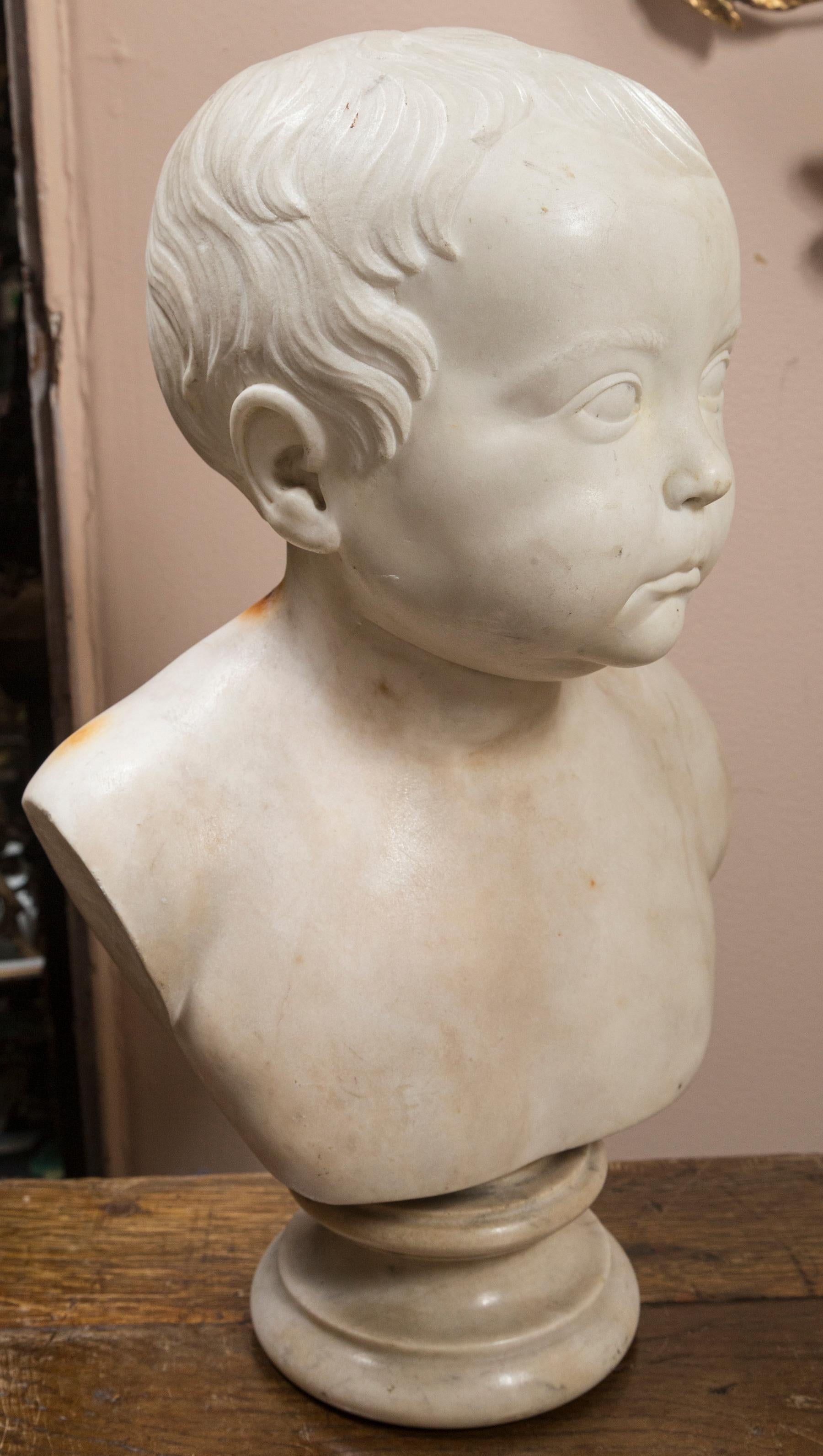 Cherubic face, signed on the back with the following inscription BUST OF R HETHERINGTON
 AGE 11 MONTHS
 W. SPENCE, FECIT 
 L POOL 1837
The round socle measures 4.75 in diameter.