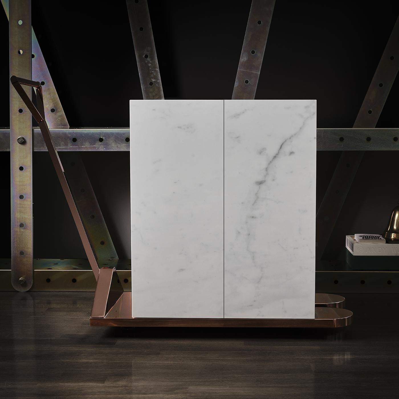 This marble two-door cabinet is inspired by the world of mechanics: sleek, efficient and ultra-functional. Boasting a copper support with wheels for optimal practicality, this piece is produced in collaboration with famous Lebanese designer Samer