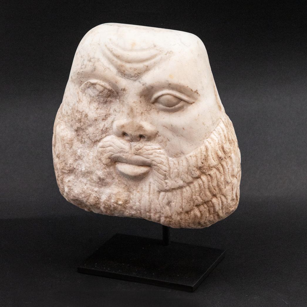 Marble carved face of bearded man. Middle-Eastern-style carved marble face of bearded man, mounted on custom black metal base. Measures: 10