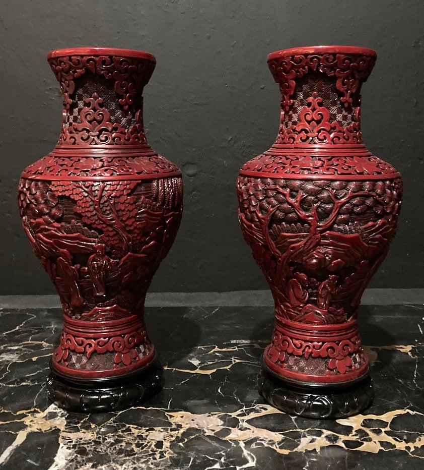 A unique pair of Japanese vases, finished in blackened red lacquer, set upon a carved black basalt base.

Intricate carving detail of traditional scenes throughout, and finished in a deep blackened lacquer.

Size : H 28 x W 14cm

Weight 9 kg