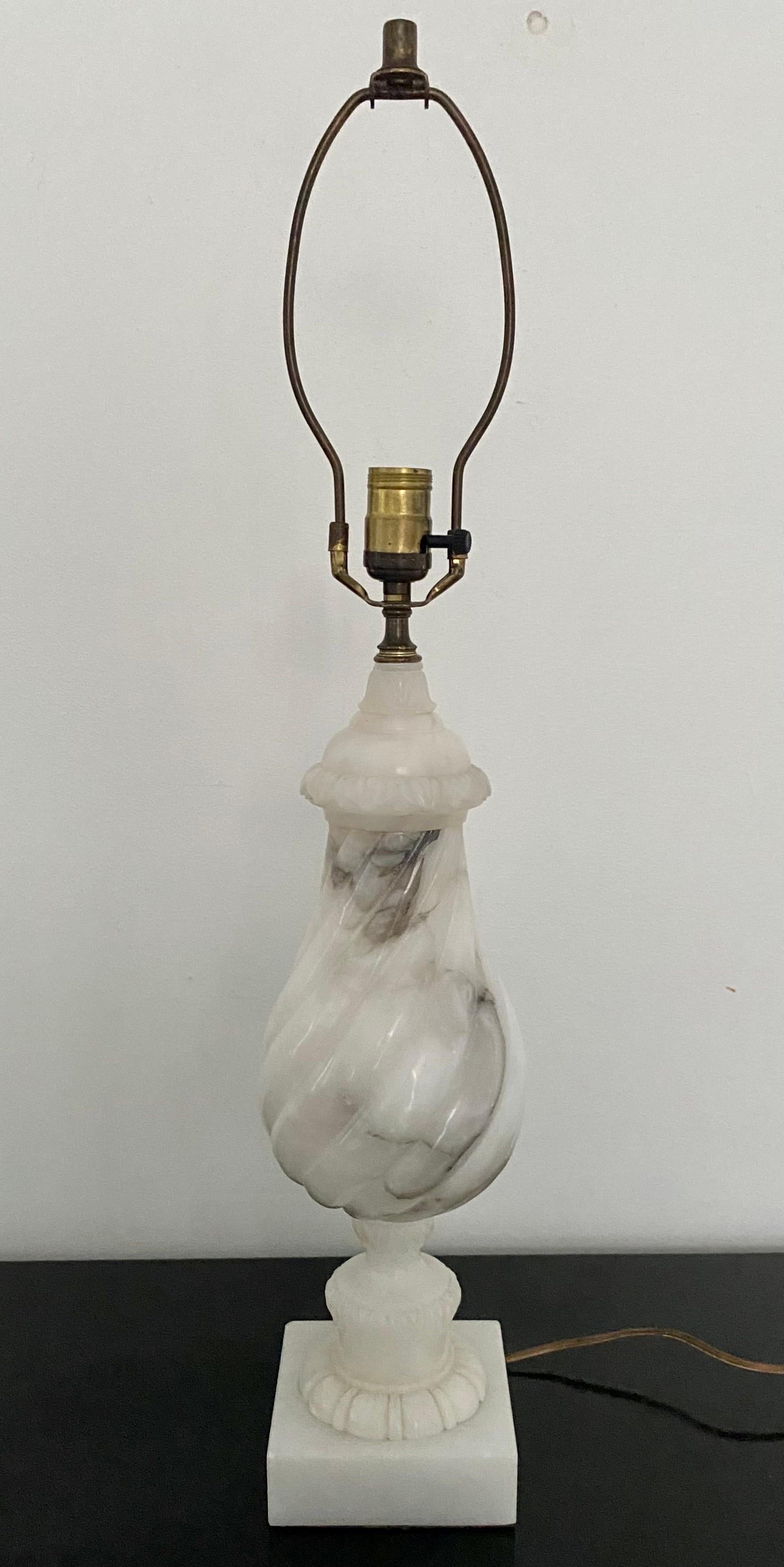 Sizable mid 20th century twisted balustrade marble table lamp mounted on a sqaure plinth base. This Neoclassical style urn form lamp features beautiful veiling and hand carved details. Lamp shade not included. 

Measures: 30 inches high to
