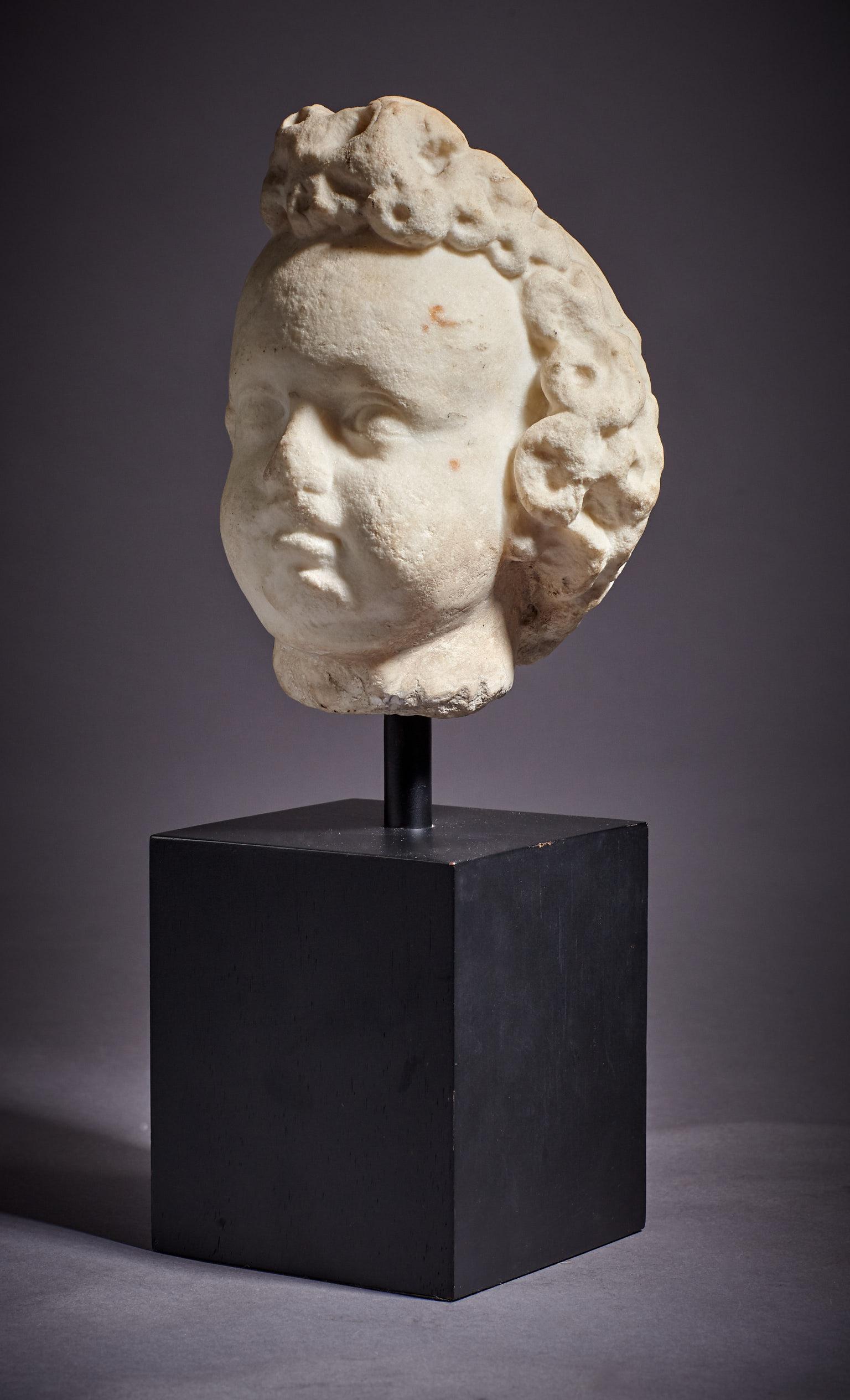 Small late 16th-early 17th century marble cherub head, Italian, circa 1600-1620

Finely sculpted in the round in high relief, of a cherub with curling hair.

Mounted on modern wooden base, mounted height is 14.5