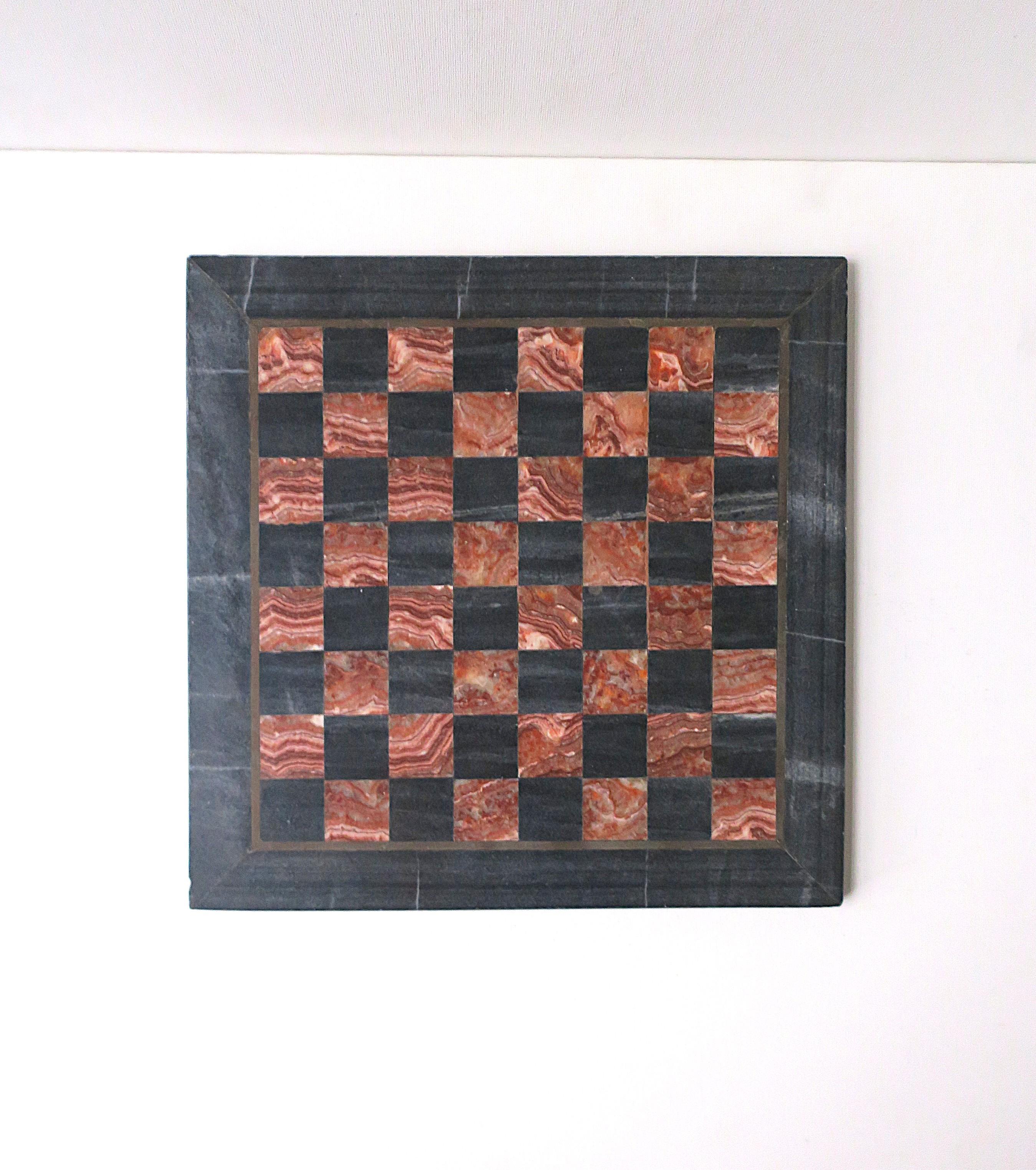 A substantial black and red burgundy marble chess or checkers game board (less the game pieces.) Board makes a great decorative object or can even be used for entertaining (trivet, serving board, etc.), circa mid-20th century.