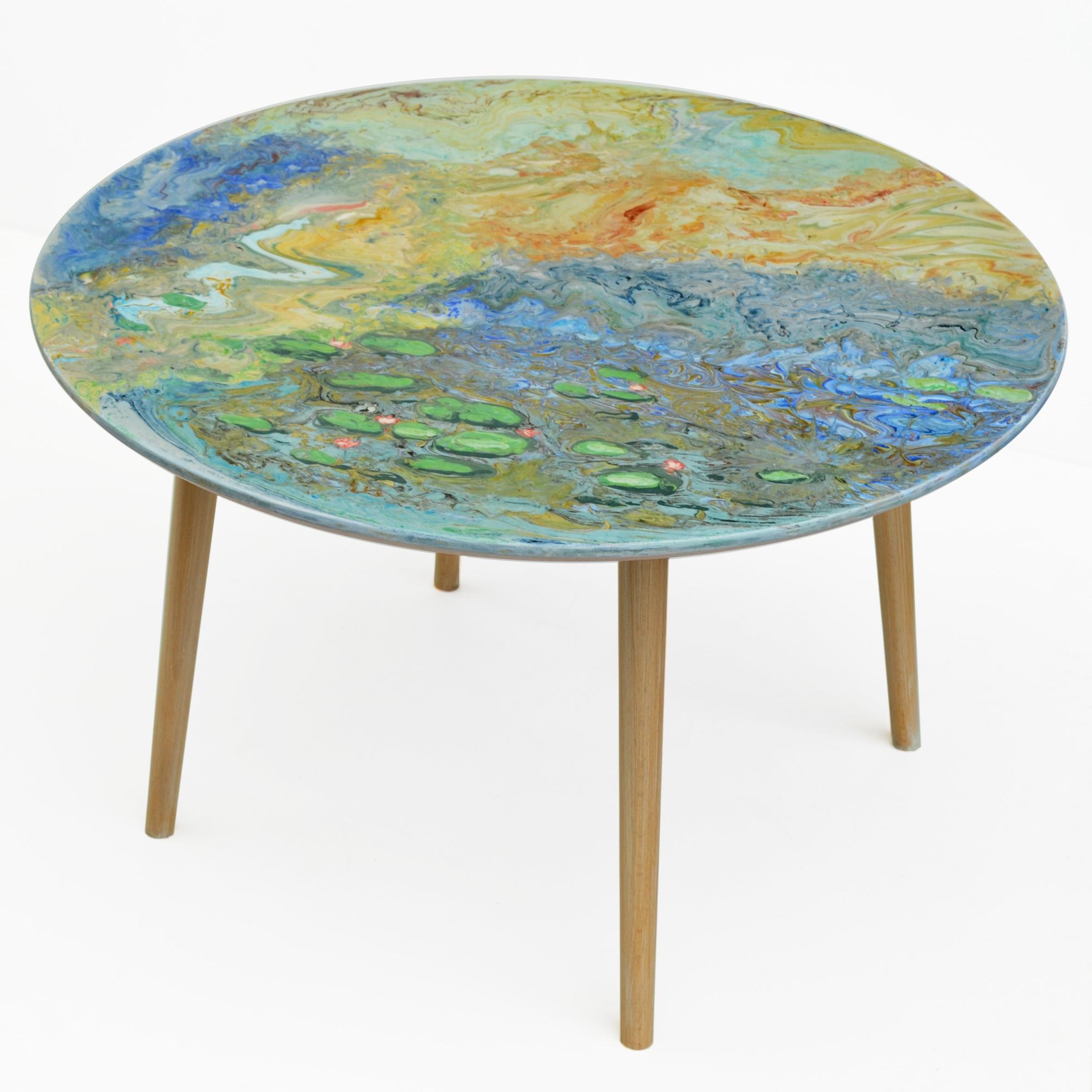 This small table made with marble top decorated entirely with scagliola art inlaies, whose decoration is a tribute to the French artist Monet and resumes its famous water lilies in a rather abstract vision. The base is made of natural wood with 4