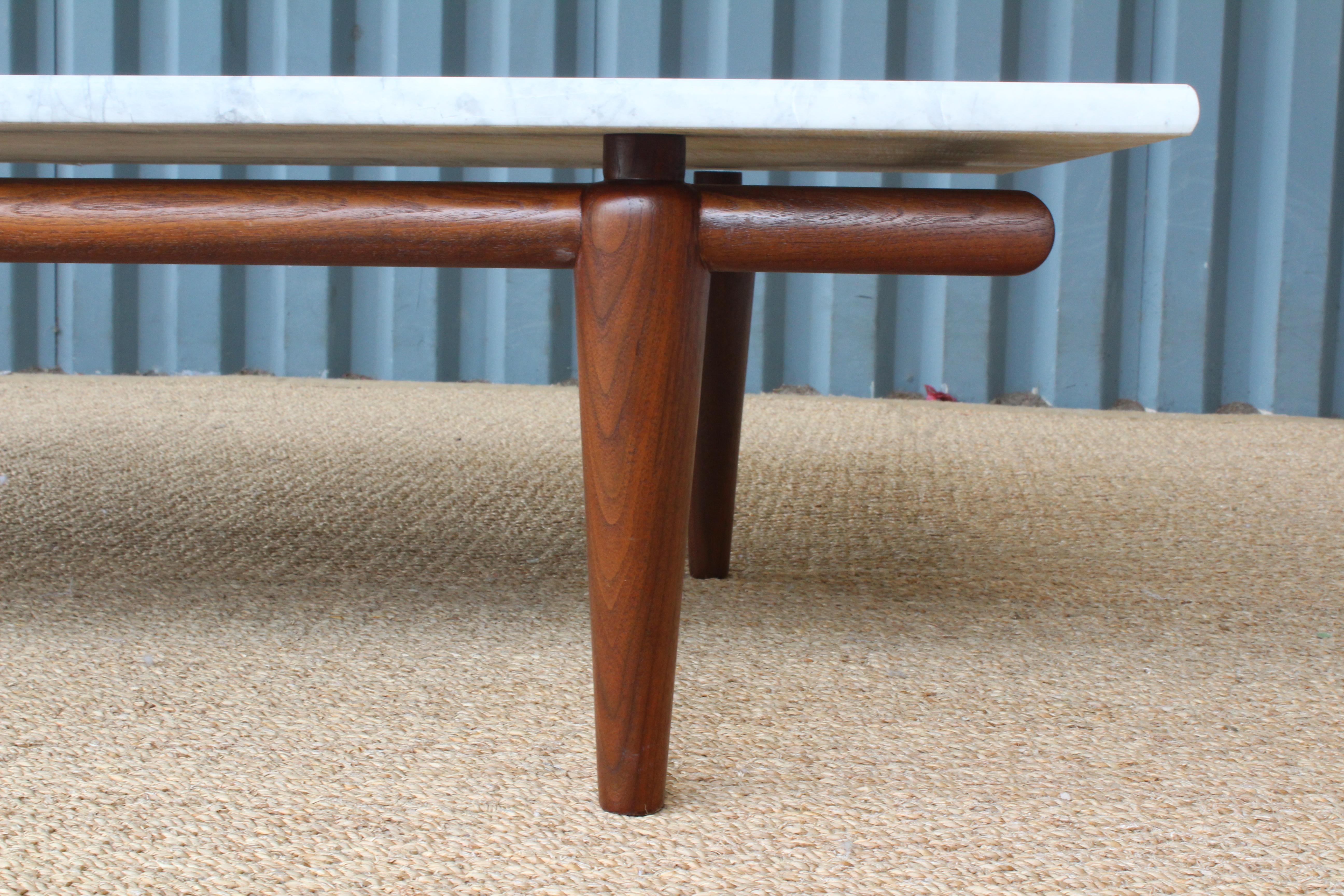 Marble and walnut coffee table. The base is an original John Widdicomb design. Marble top is new and custom cut to fit the table. The walnut base has been refinished.