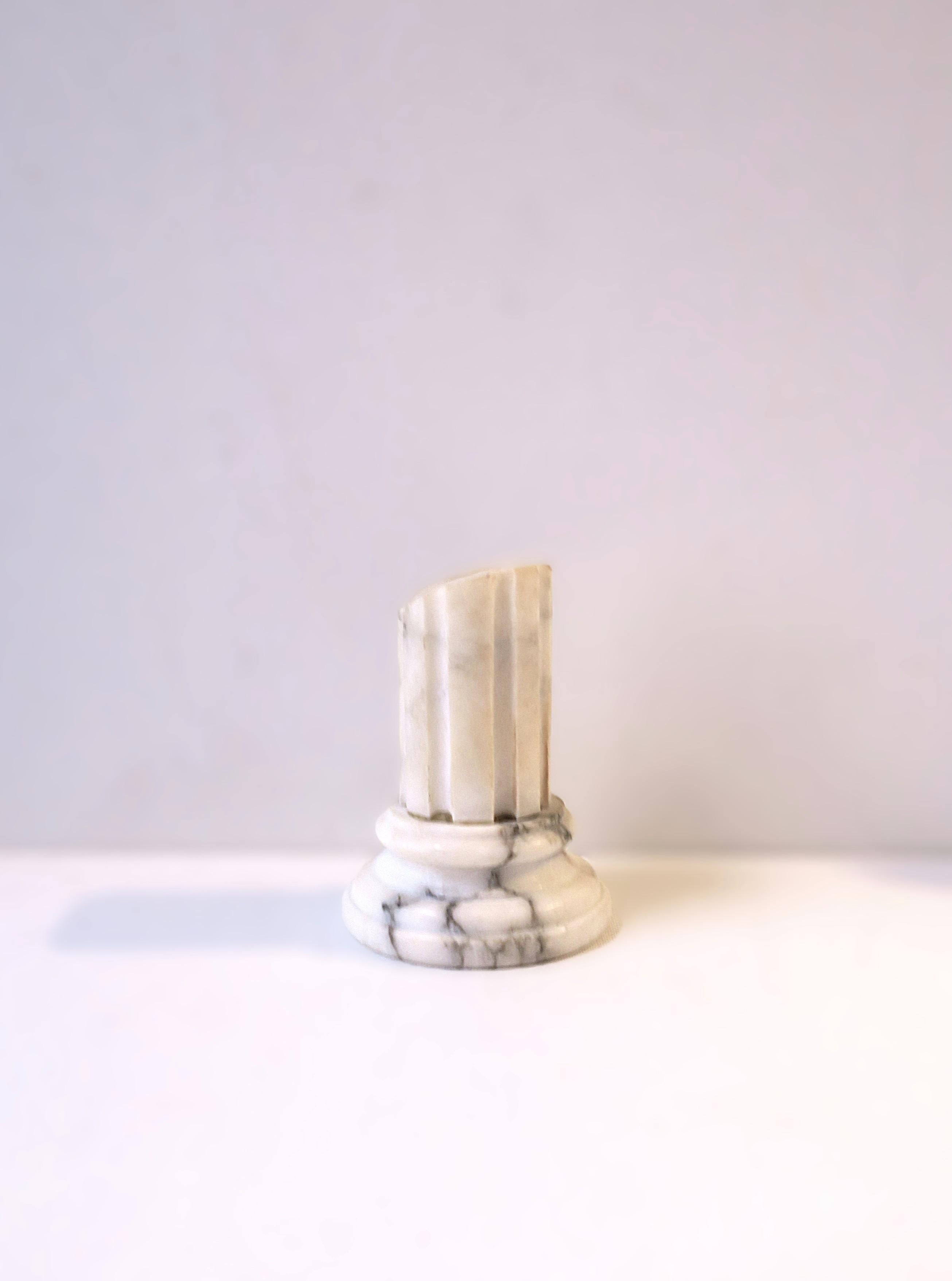 An Italian Carrara marble column decorative object, Neoclassical design style, circa early to mid-20th century, Italy. Piece is Carrara marble - white with black veining, a circular graduated base and a fluted pillar. Obelisk shown available