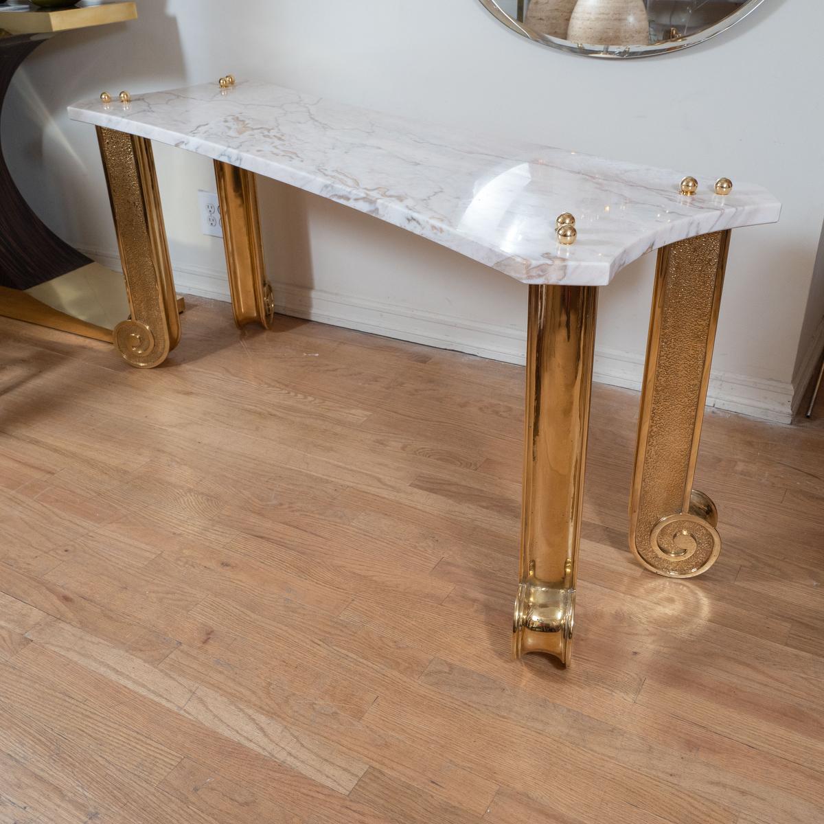 Marble console with brass fluted columnar legs.