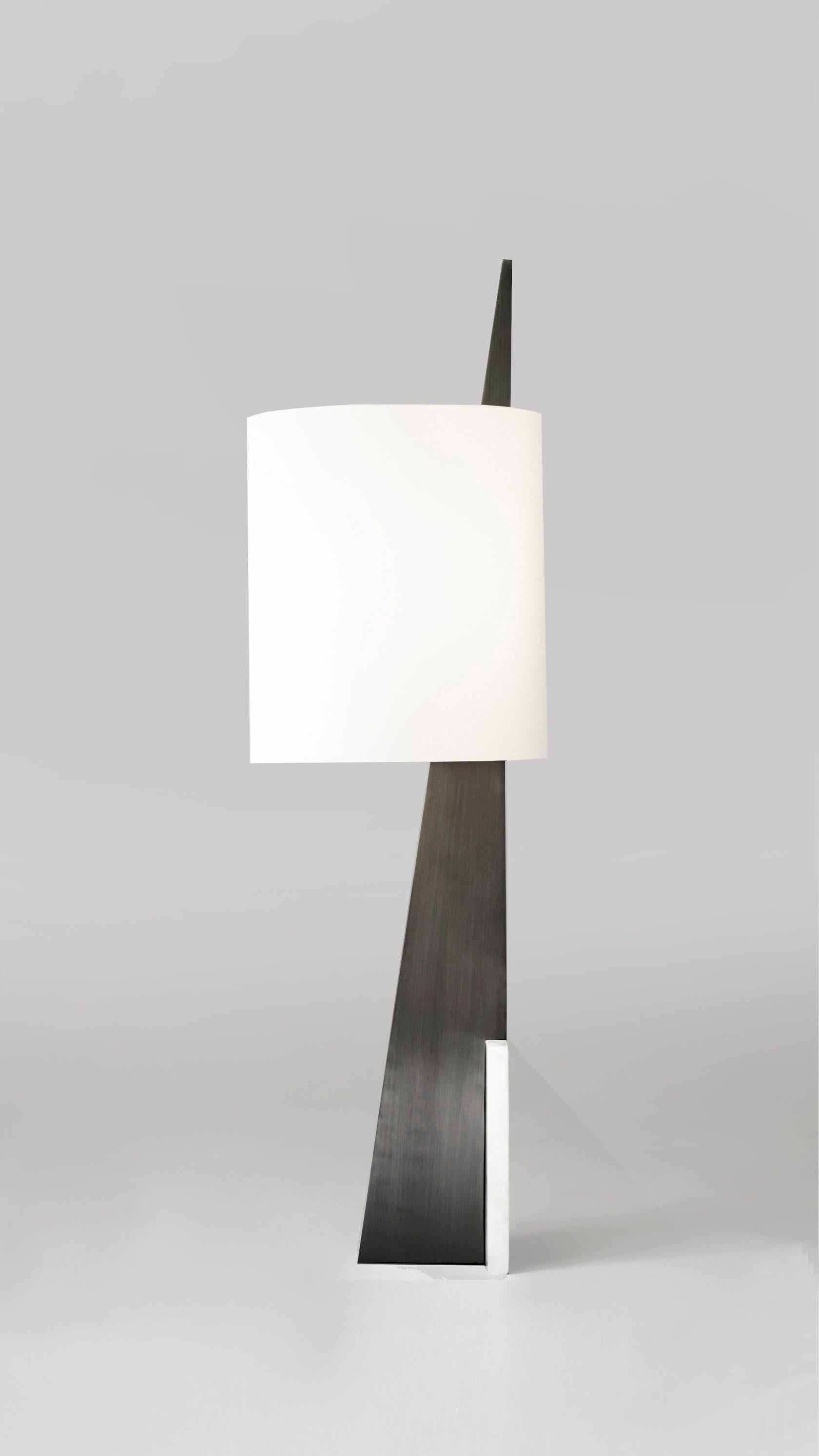 Marble Cut Triangle I Table Lamp by Square in Circle
Dimensions: 30 diameter x 102 height cm
Materials: Brushed brass finish, white frosted glass, dark grey metal  

Inspired by the El Lissitzky poster beat the whites with red wedge, this oversized