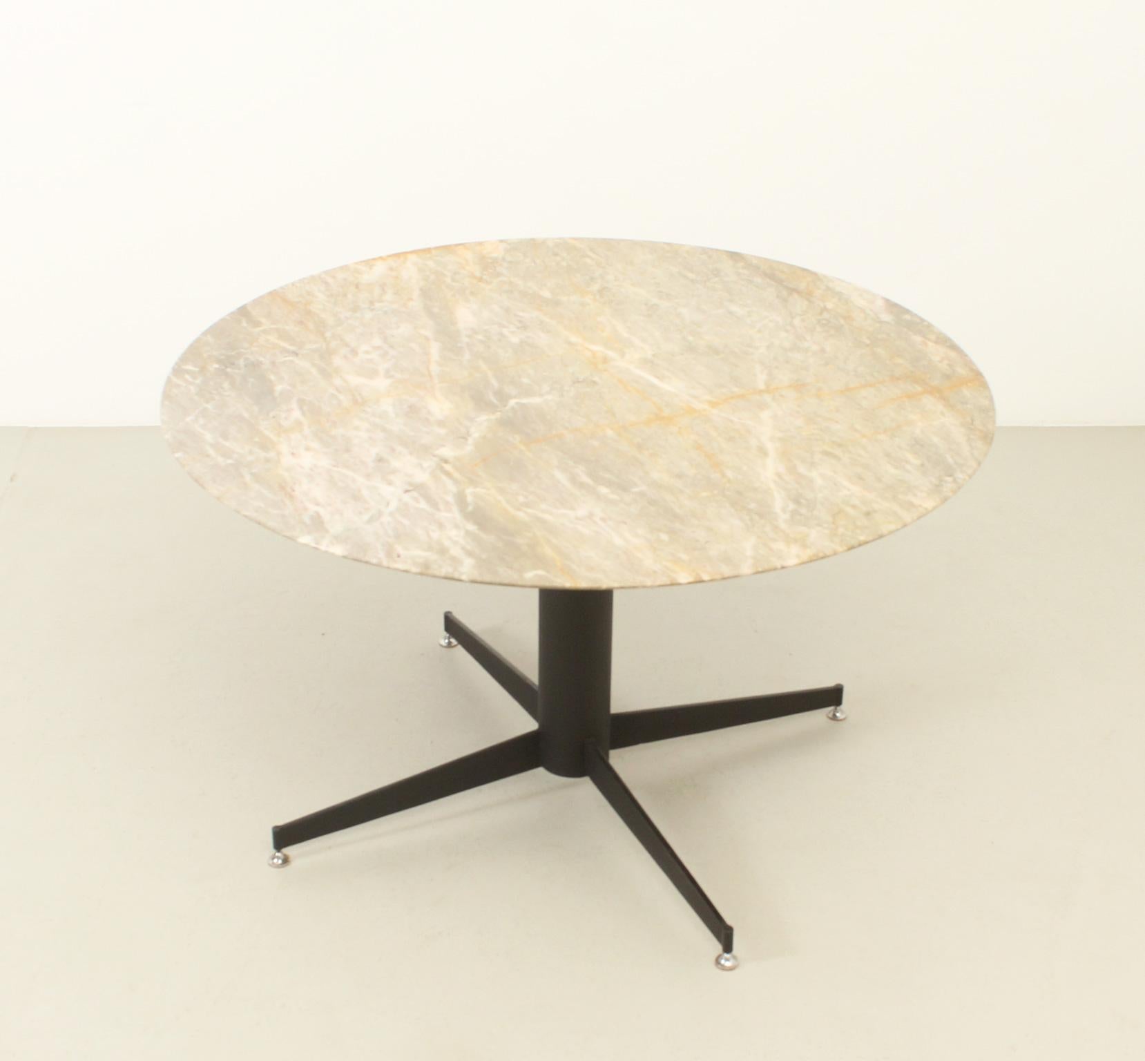 Marble dining table from 1950s, Spain. Grey marble with yellow rust veins top and black lacquered metal base with adjustable feet.